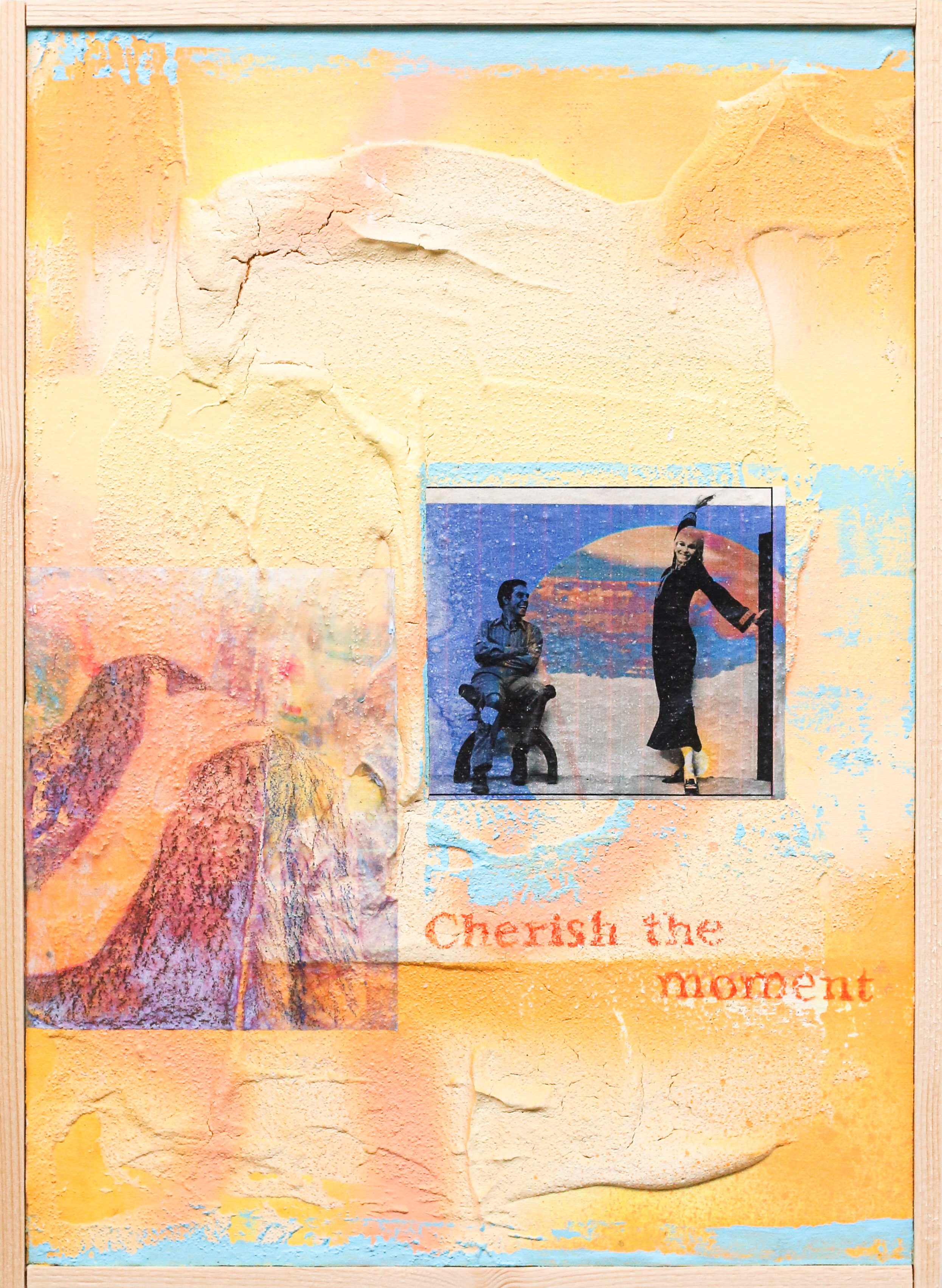 Mixed media art on textured wall featuring a small photograph of a person sitting on a chair and another person standing next to a wall, with the phrase "Cherish the moment" painted in orange below the photo, and a painted mountain scene on the left side.
