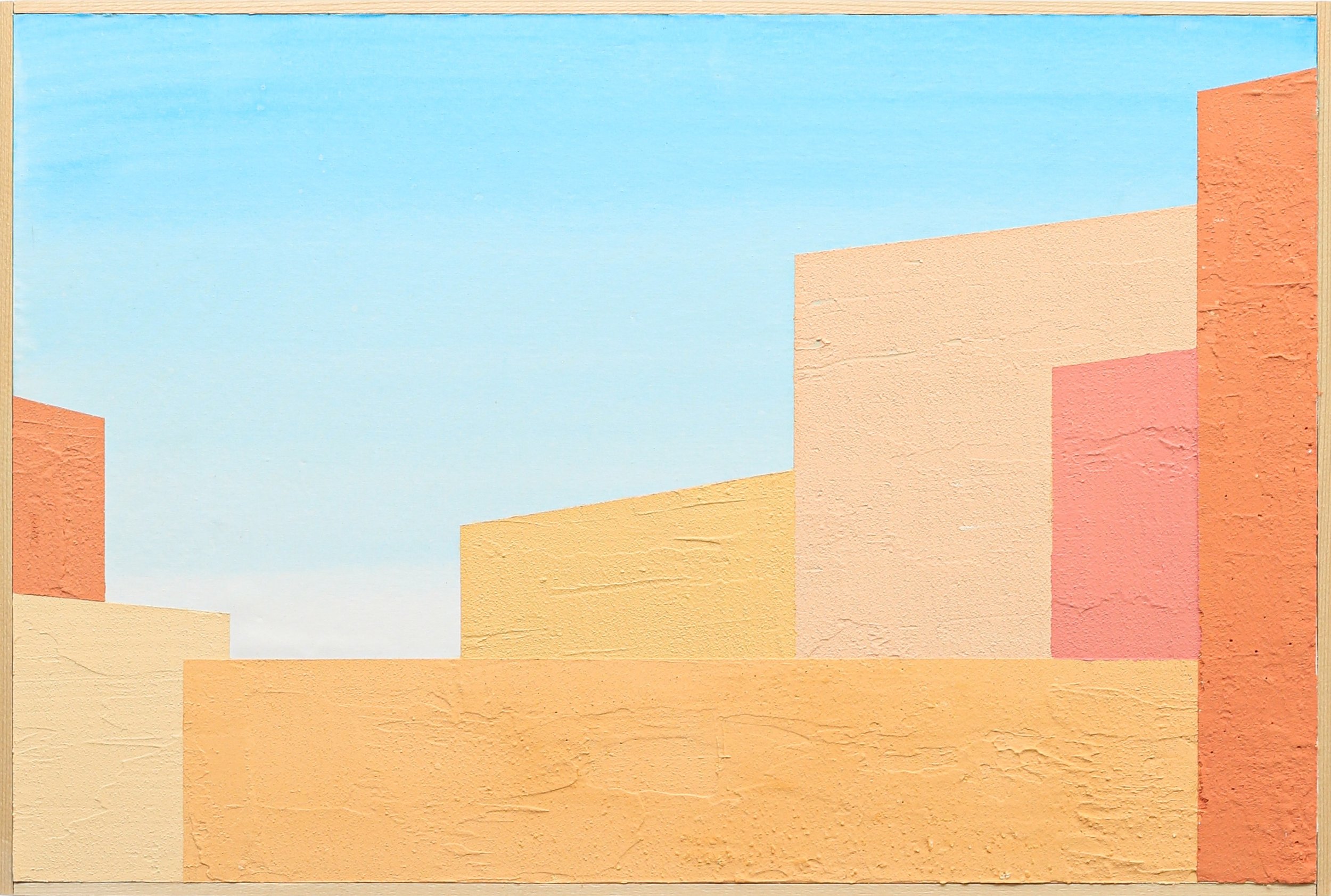 Colorful geometric building walls in shades of peach, pink, and orange with a blue sky background.