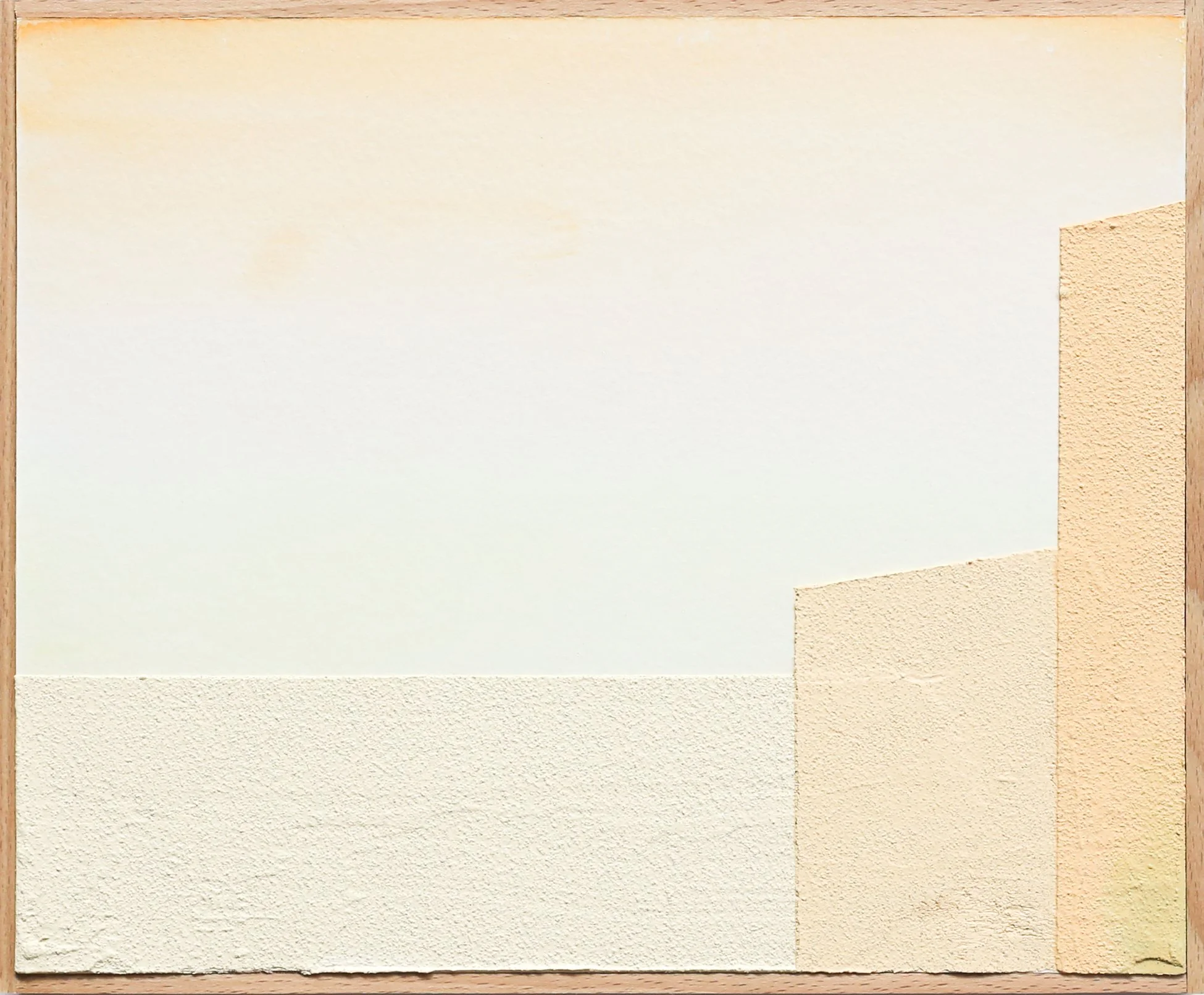 Close-up of a wall with textured beige and white sections, and a corner with a different textured beige section.