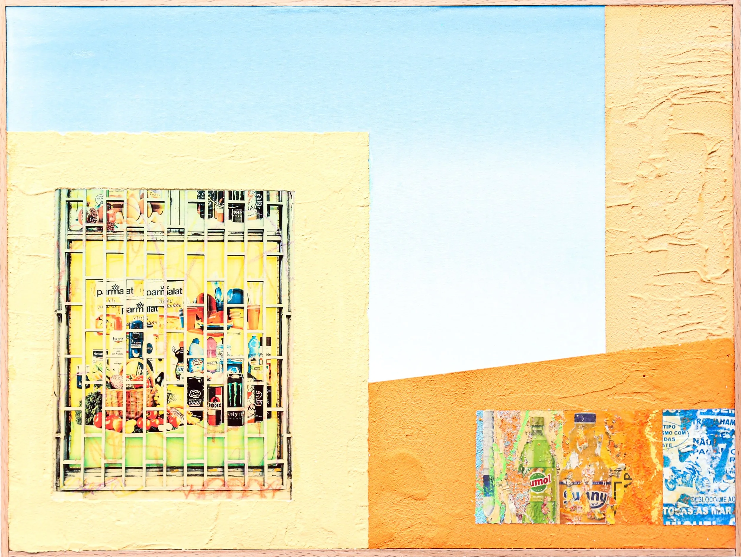 Colorful wall with a small window covered by a metal grille and a collage of advertisements for beverages and food.