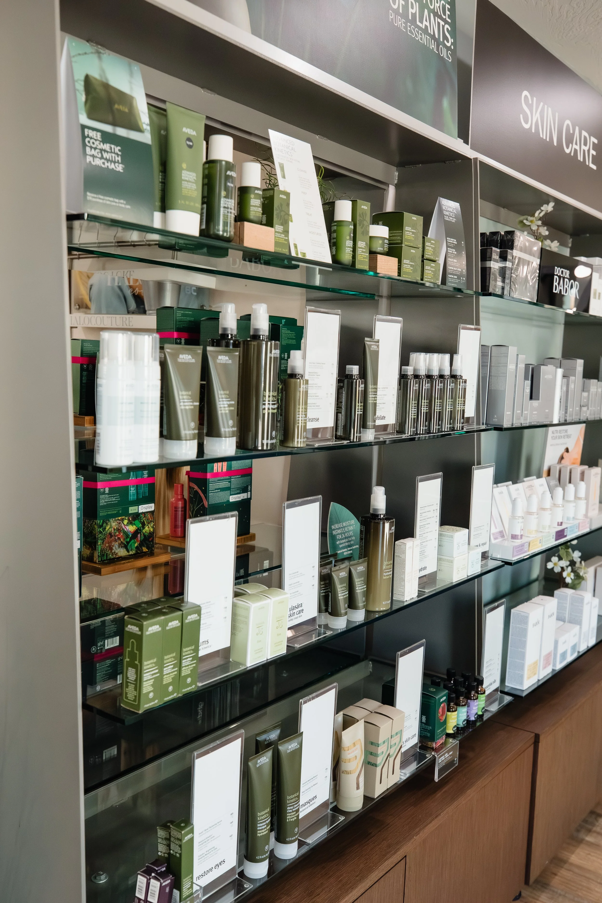 Beauty product shelves with skincare and essential oils in a retail store.