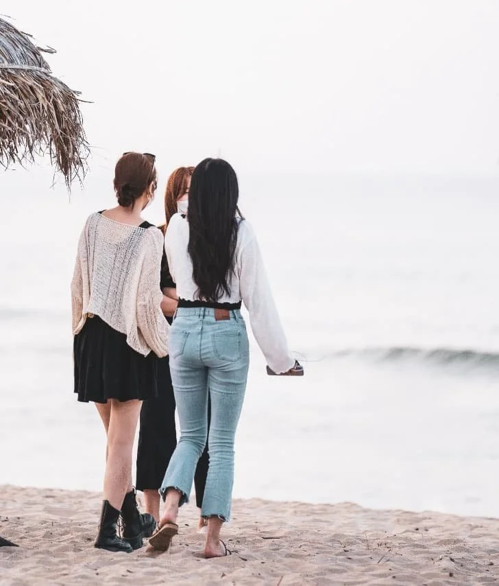 women walking on the beach