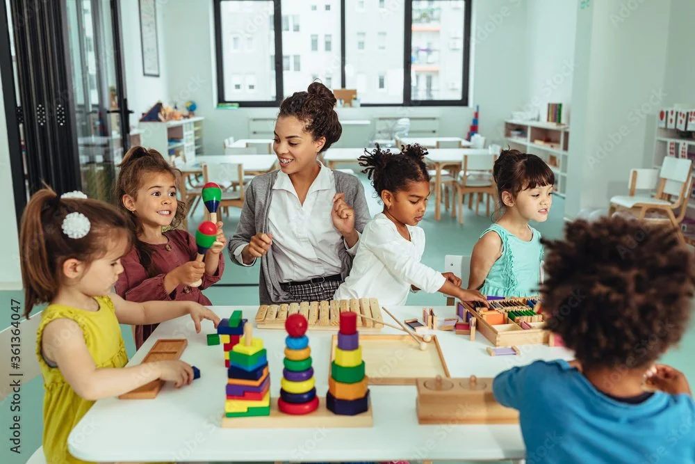 Teacher engaging young children in fun educational play activities in a safe childcare setting during an event.