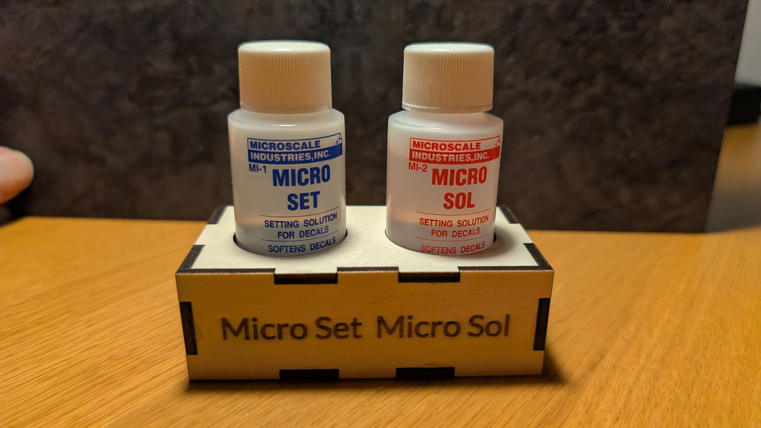 A small wooden box for Micro Set and Micro Sol both known for their "easy spill" characteristics 