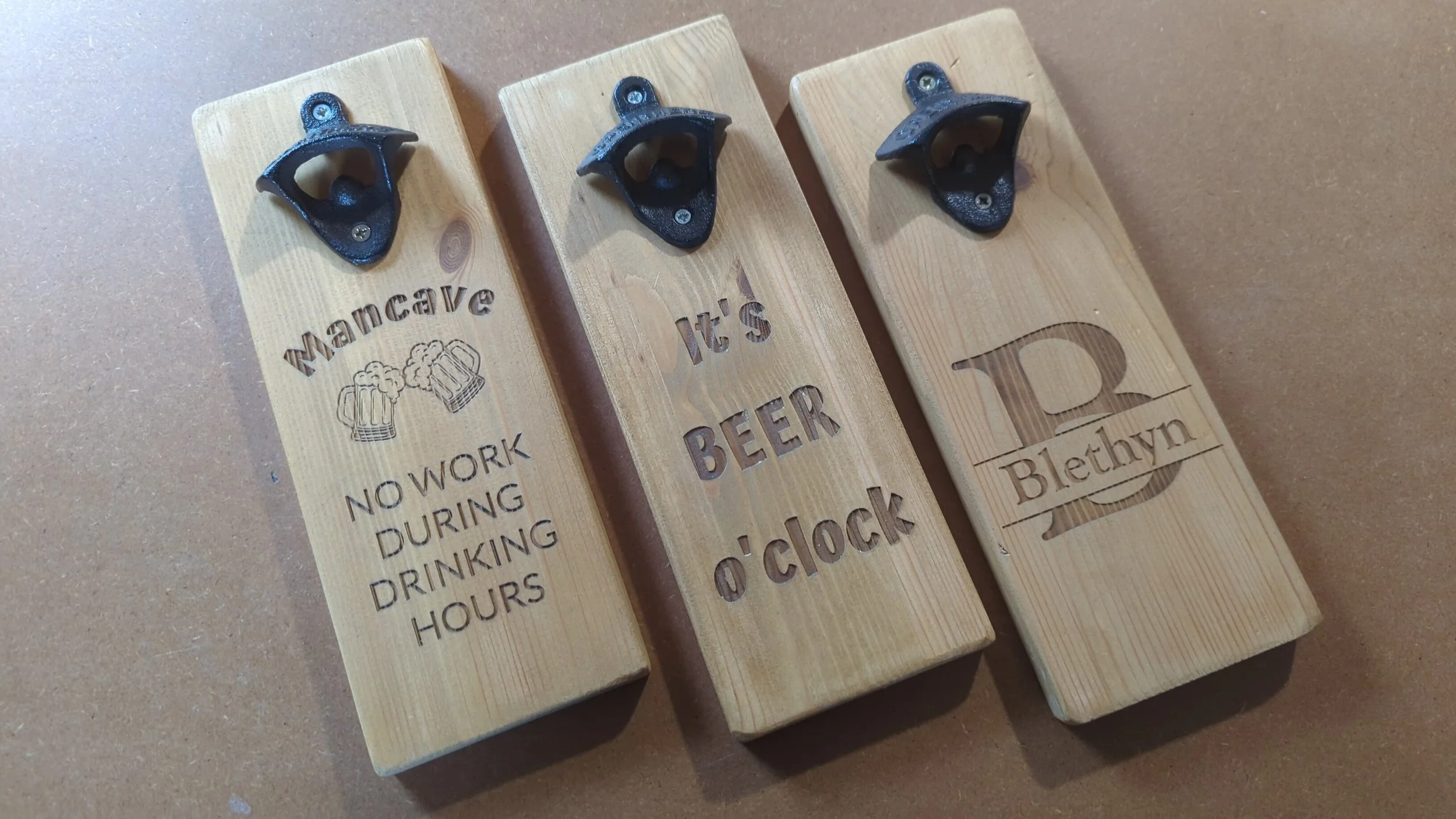 Three wooden, wall hung, bottle openers. 