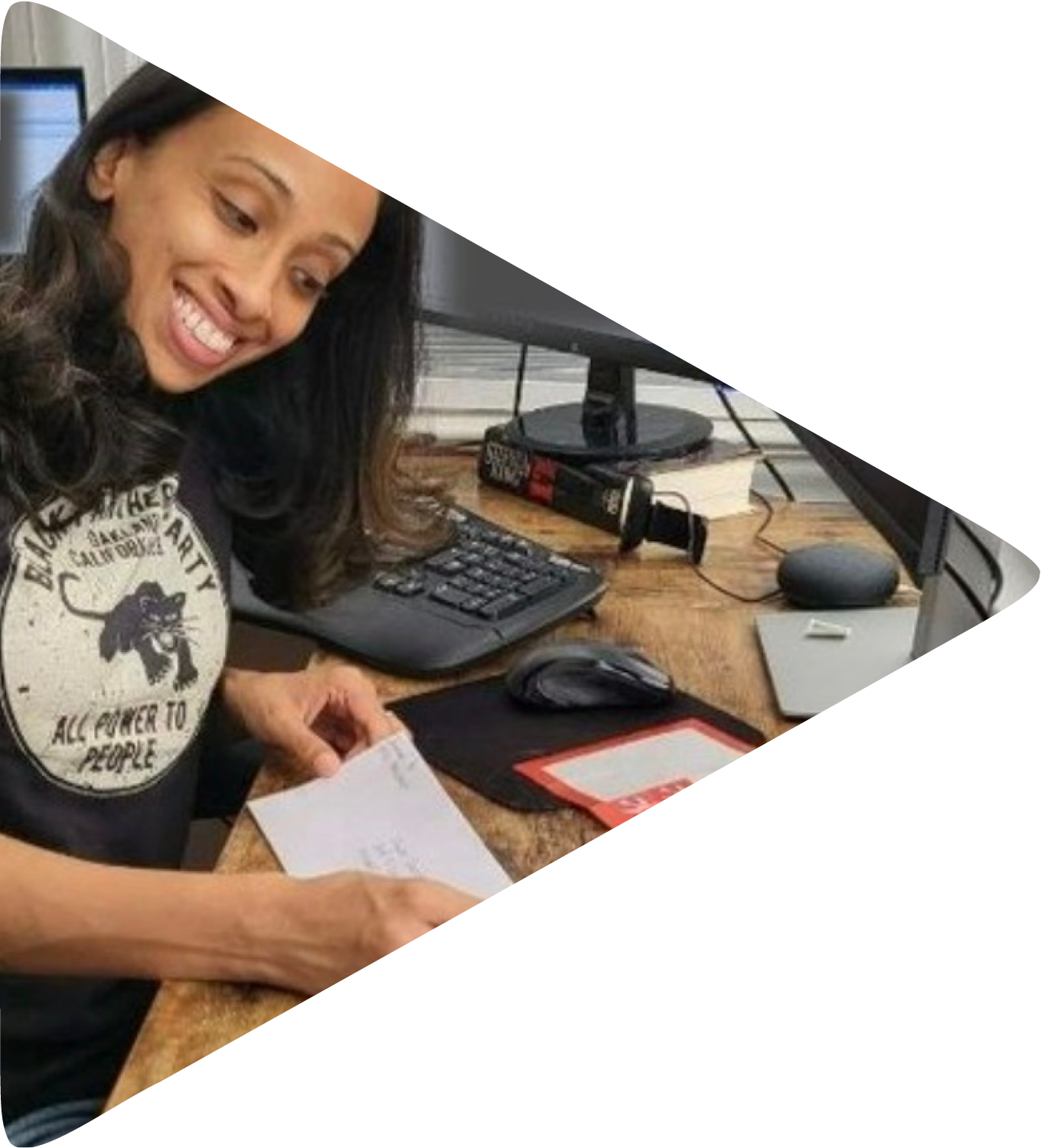 A woman sits at her desk writing a letter.