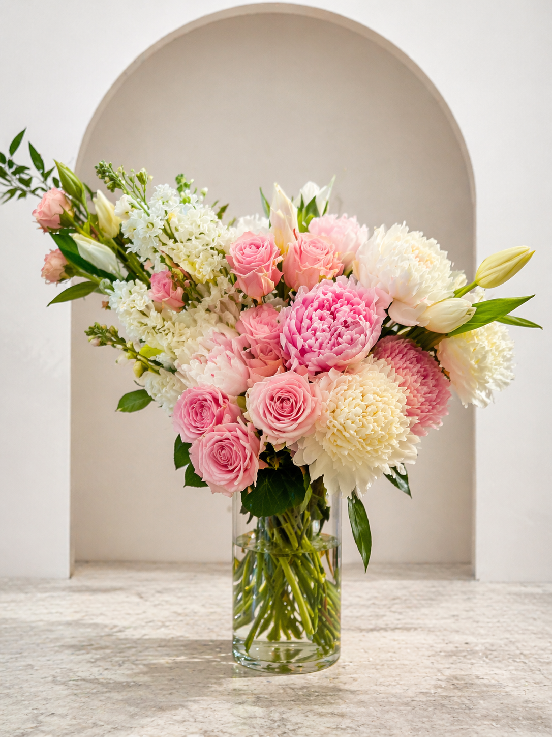 Elegant pastel floral arrangement in alcove.png