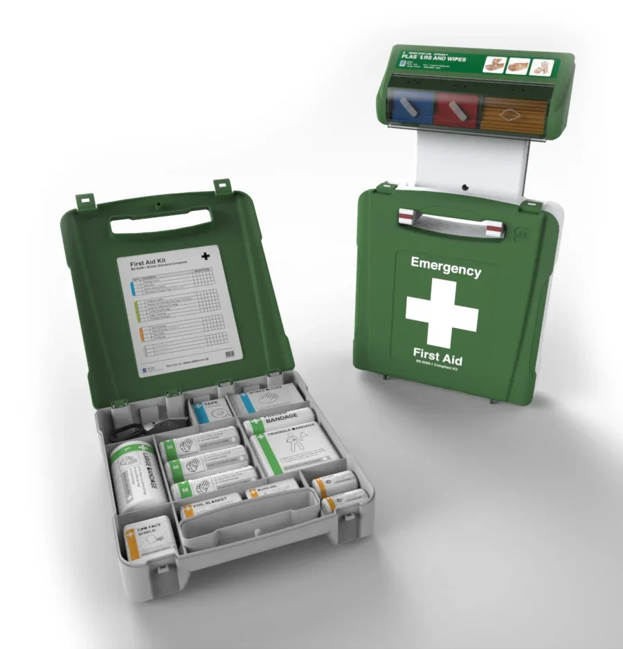 Open first aid kit with various supplies, closed emergency first aid kit, and a box with wipes, bandages, and medical tools.