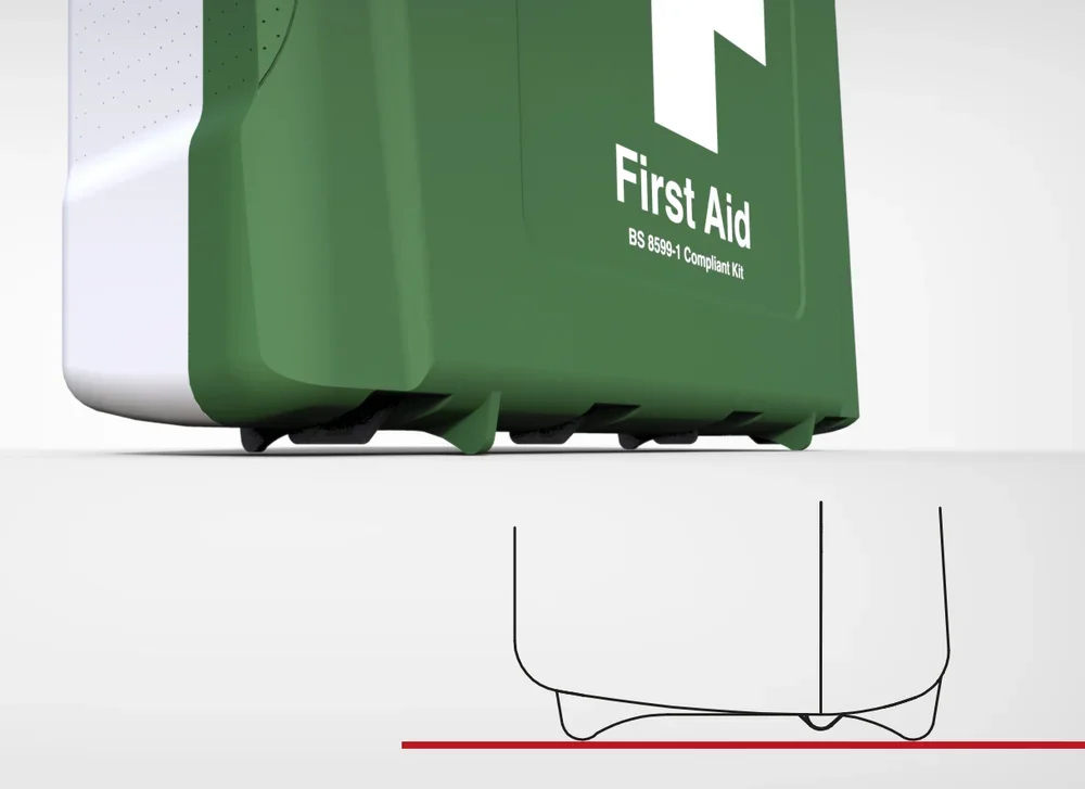 Close-up of a green first aid kit with white text, showing the bottom edge and four small wheels on a white surface.