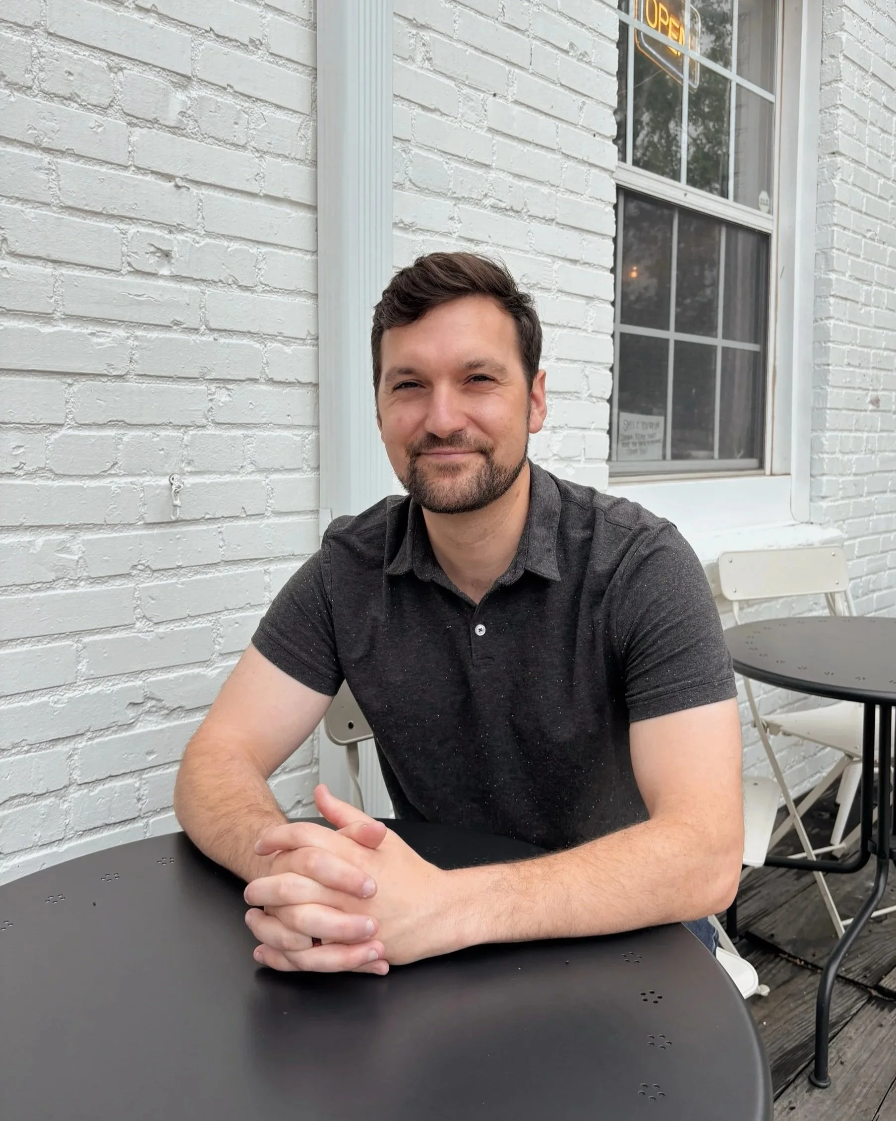 Greg Giannotti, owner of Kingdom Bookkeeping, seated at an outdoor table
