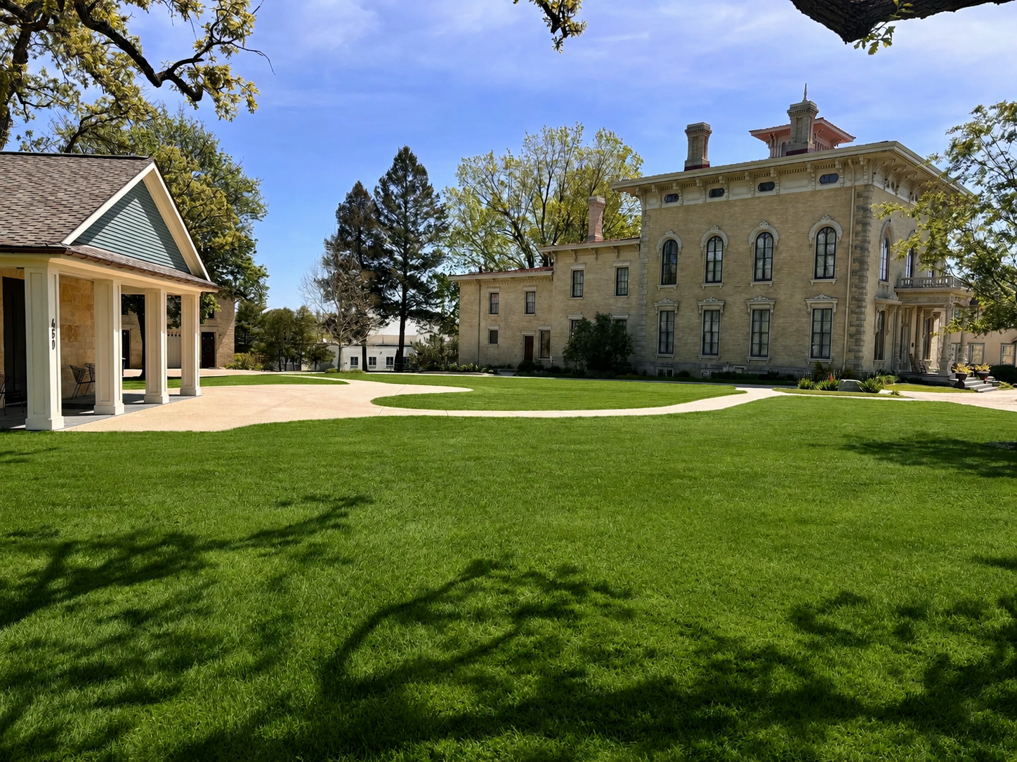 Landscaped campus between historical buildings.