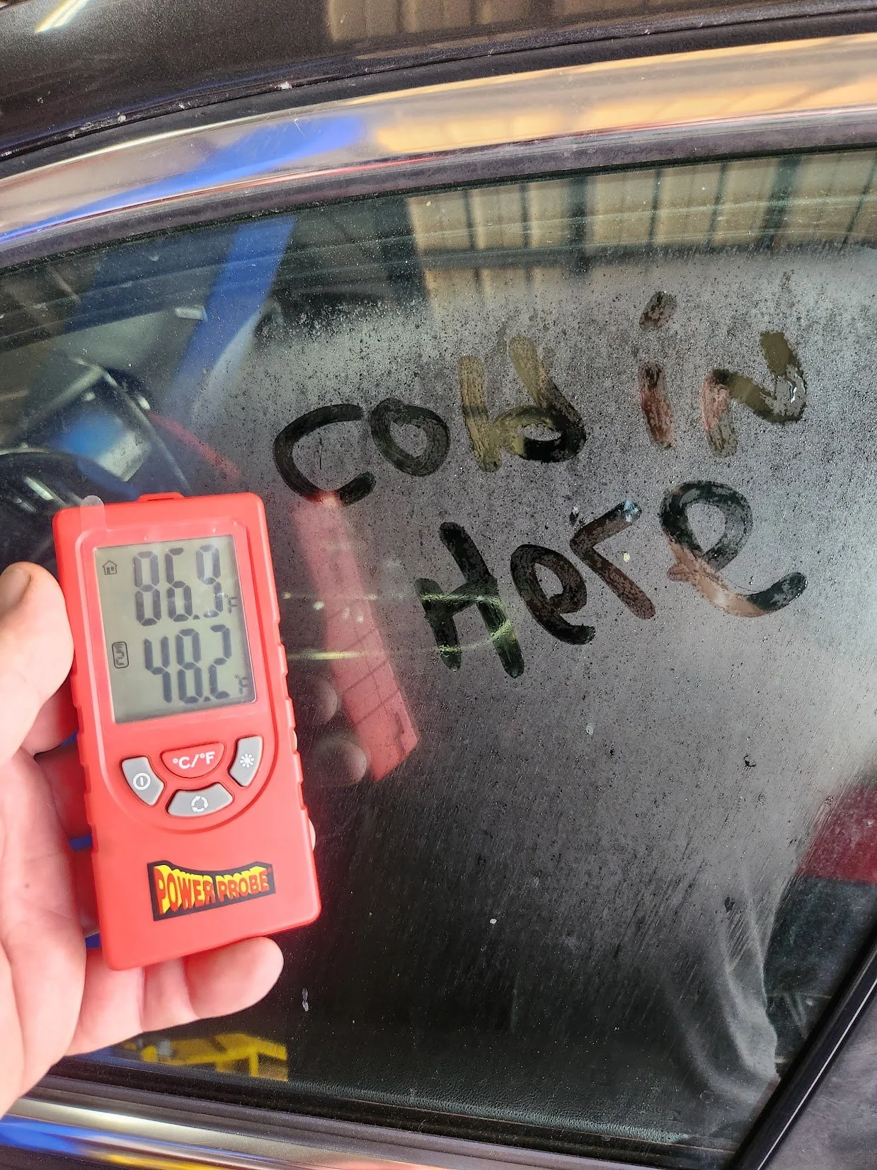 A power probe tool measuring the temperature inside of a car