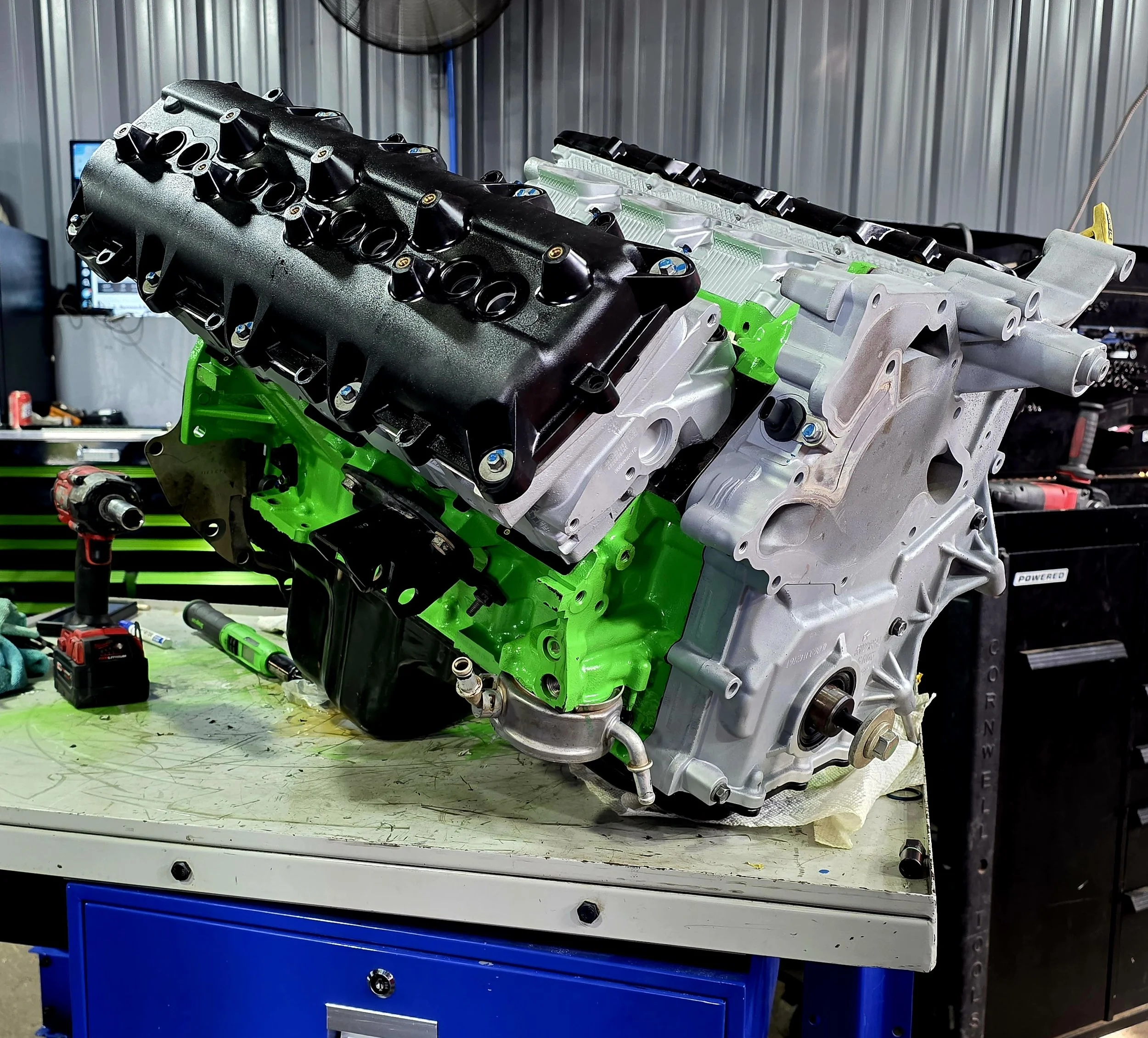 A green and grey engine completed on top of a table at Hollin Car Care