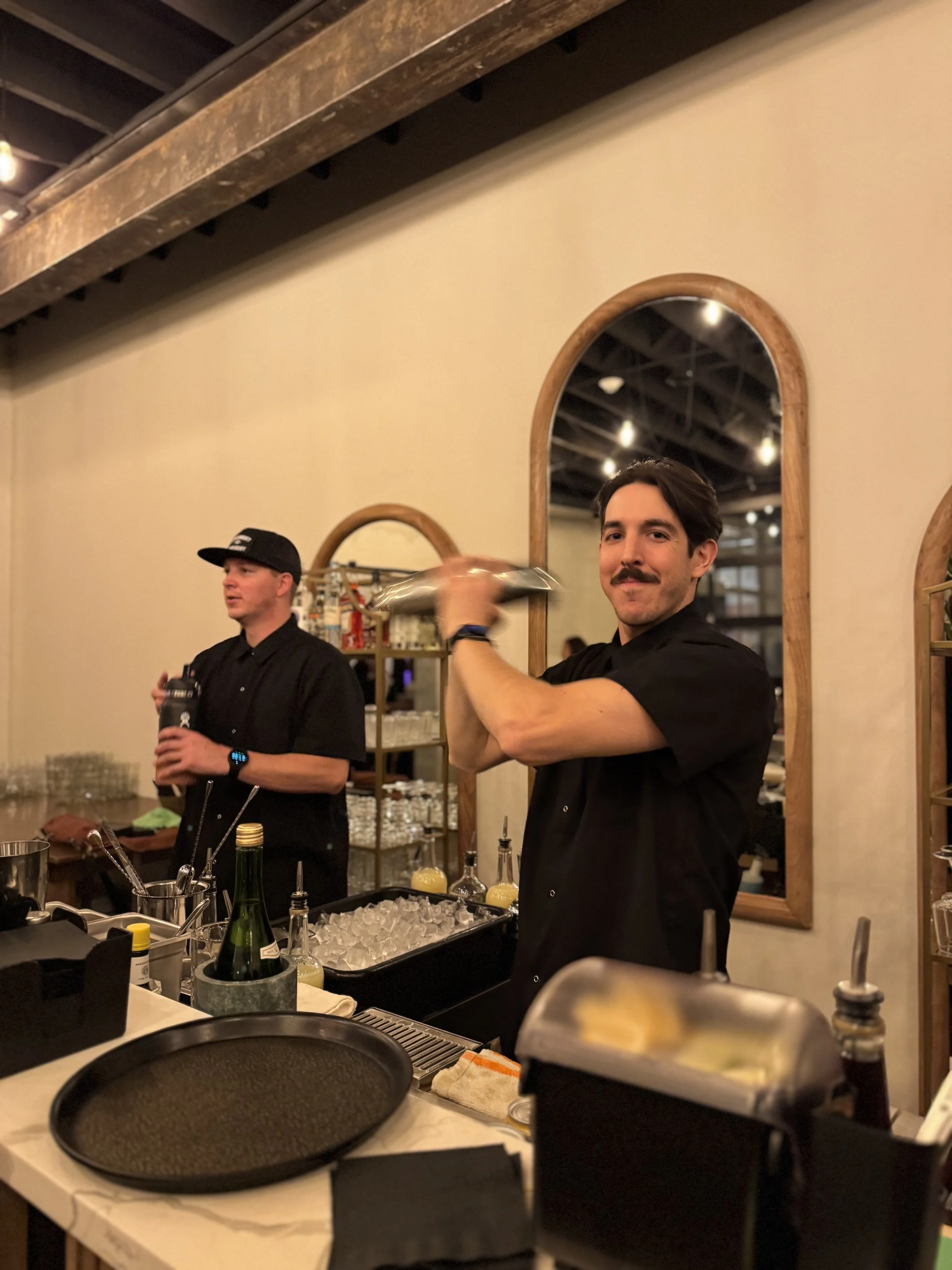 bartender shaking a cocktail at an event
