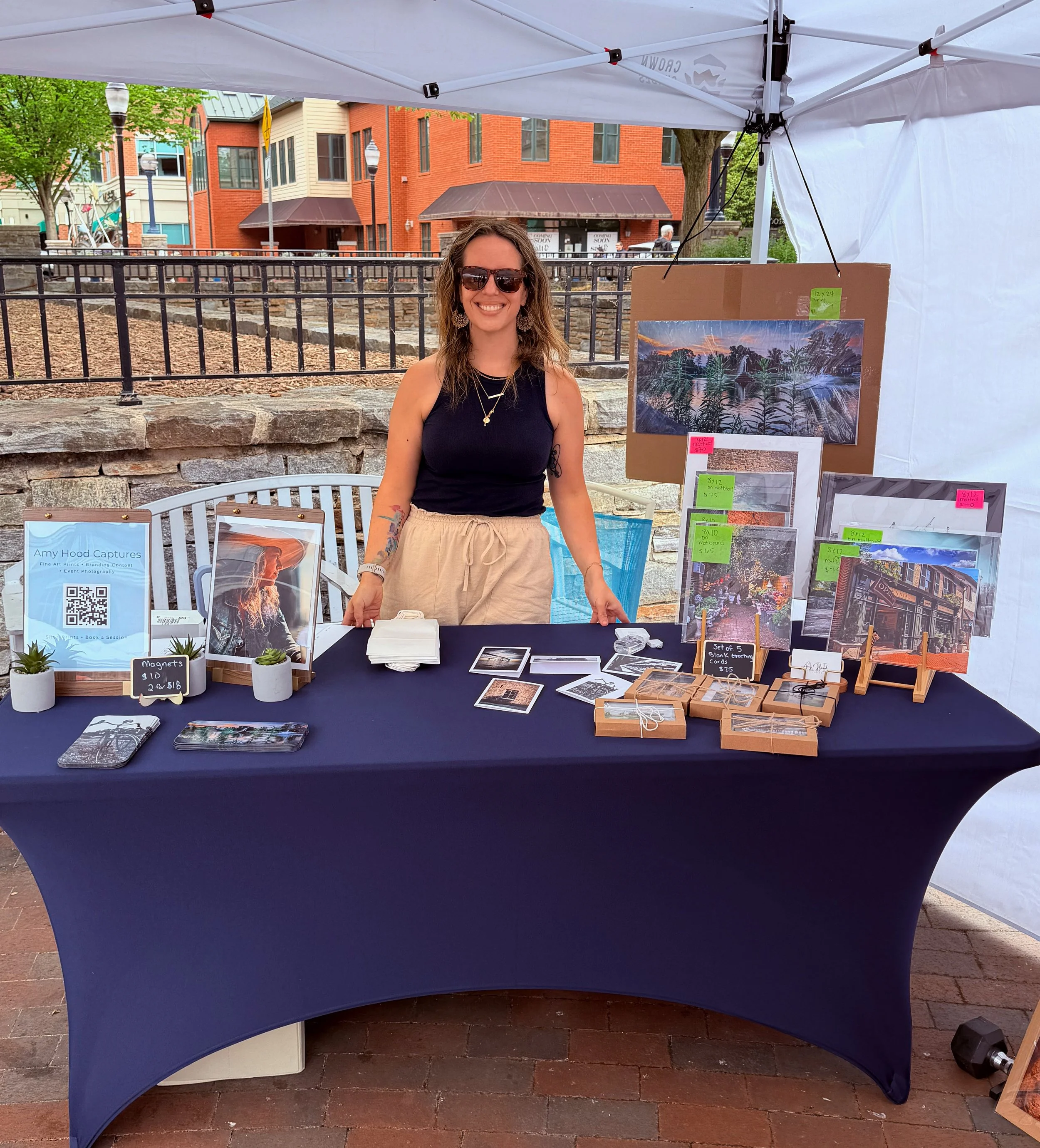 Amy Hood behind the Amy Hood Captures fine art photography booth at Frederick Spring Fest in Frederick, MD