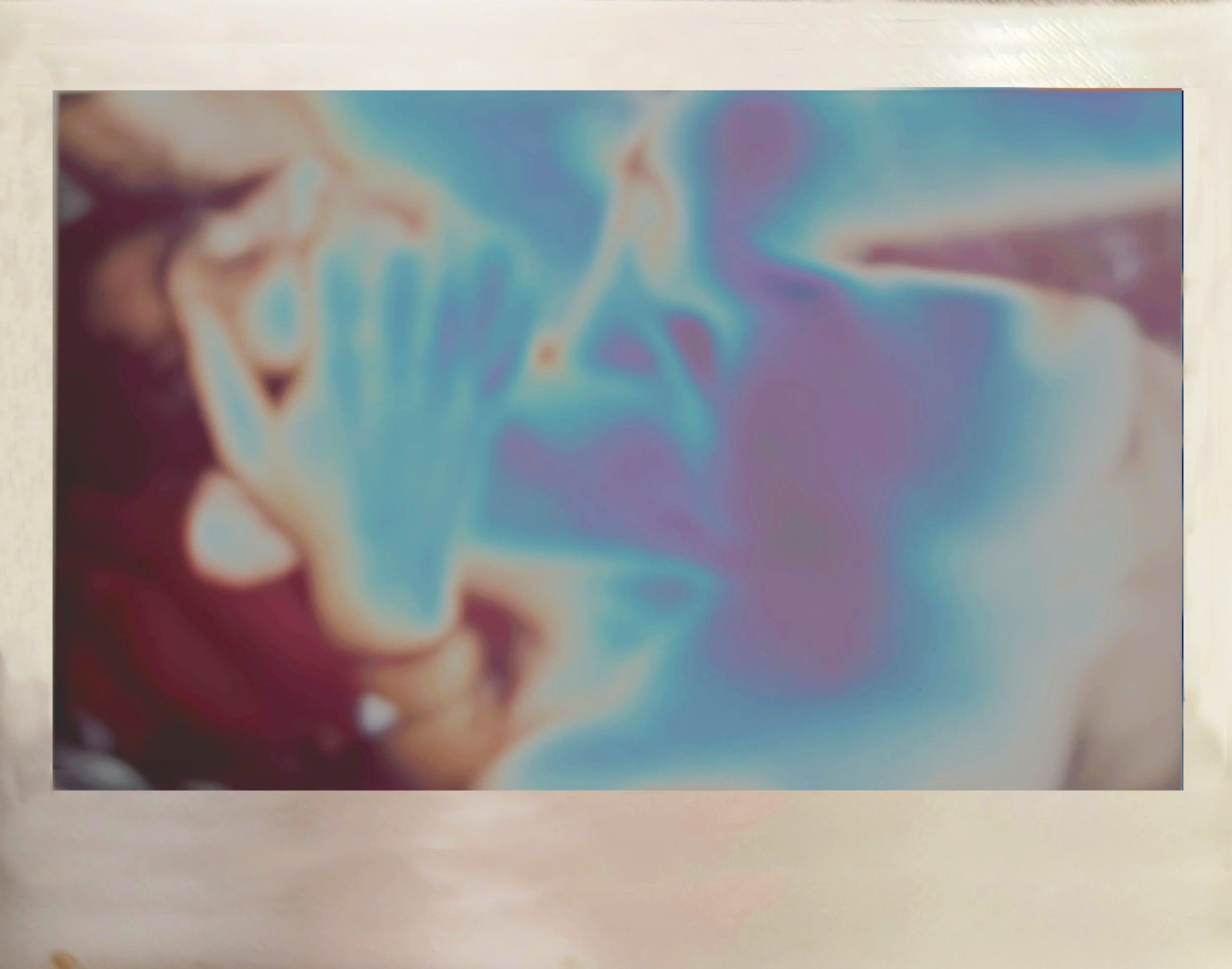 Blurred abstract image with shades of blue, purple, and beige.