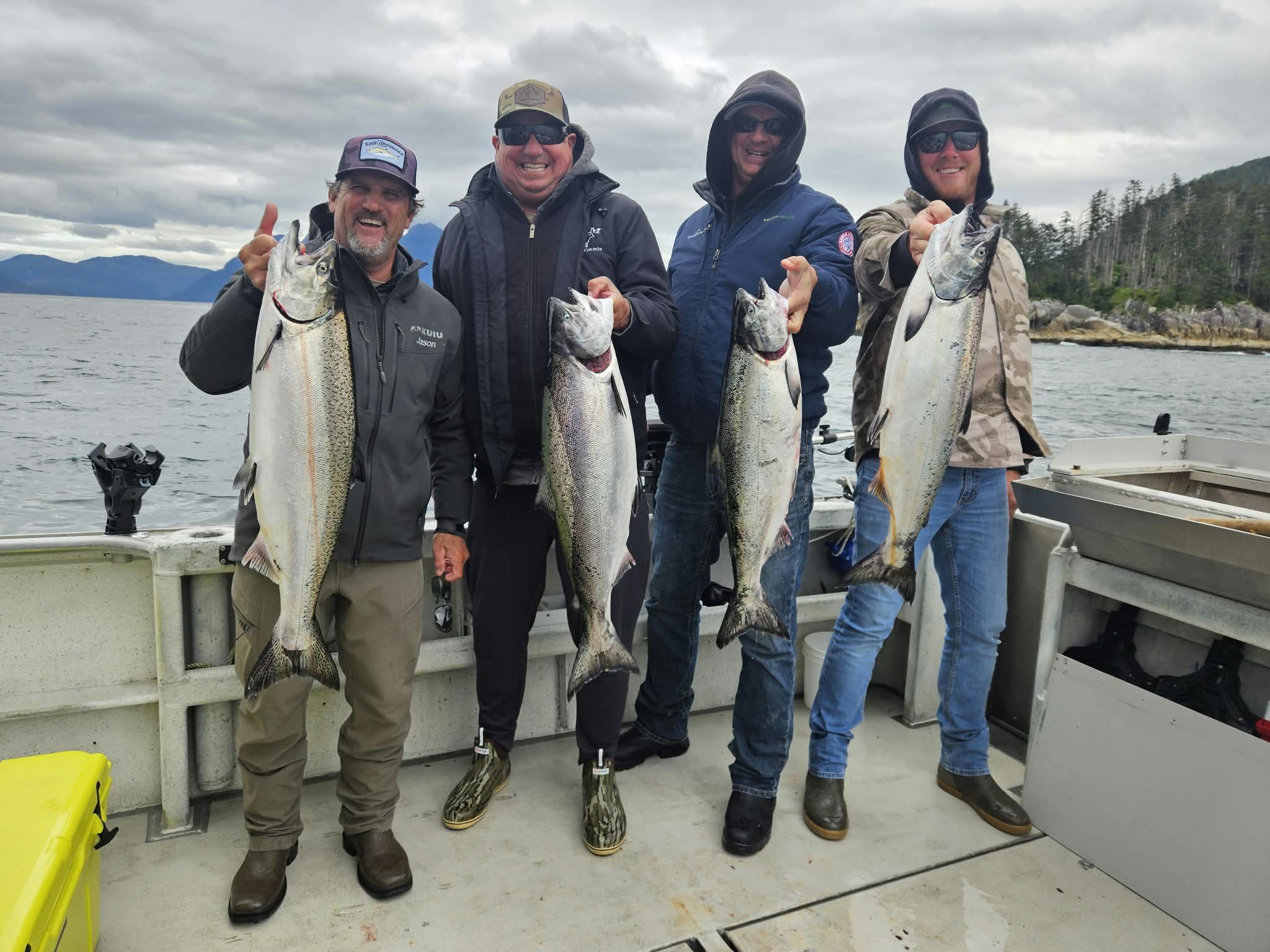 Group of people holding king salmon