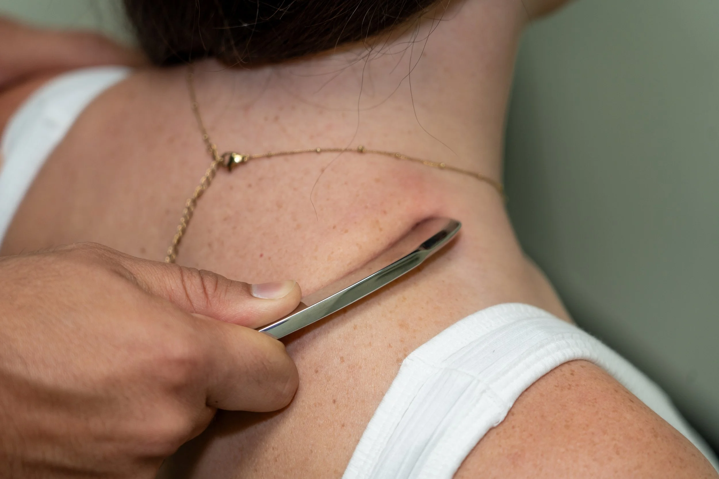 Soft tissue therapy on trapezius muscle