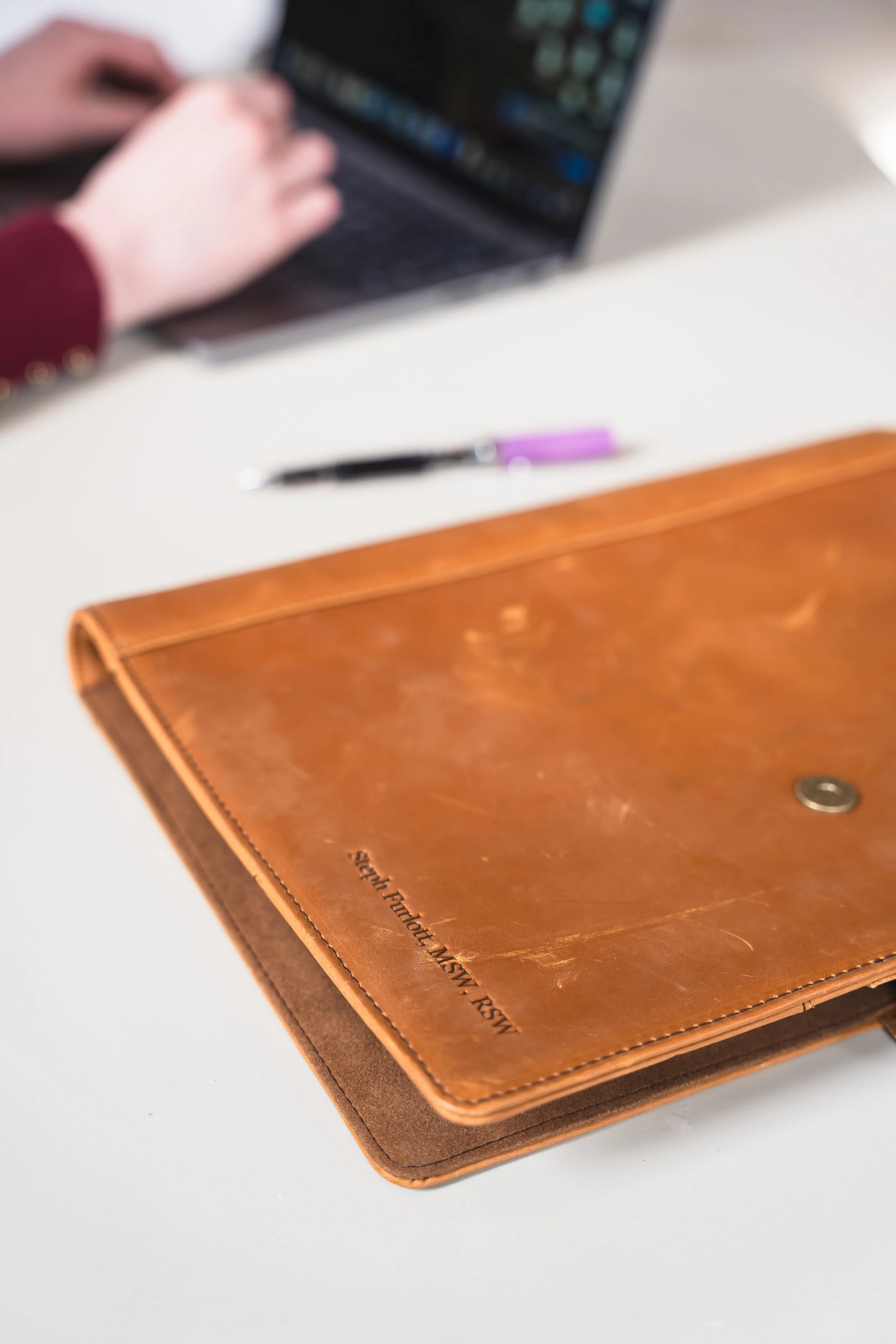 A therapist for disordered eating in Ontario's brown leather notebook with RSW pressed in.