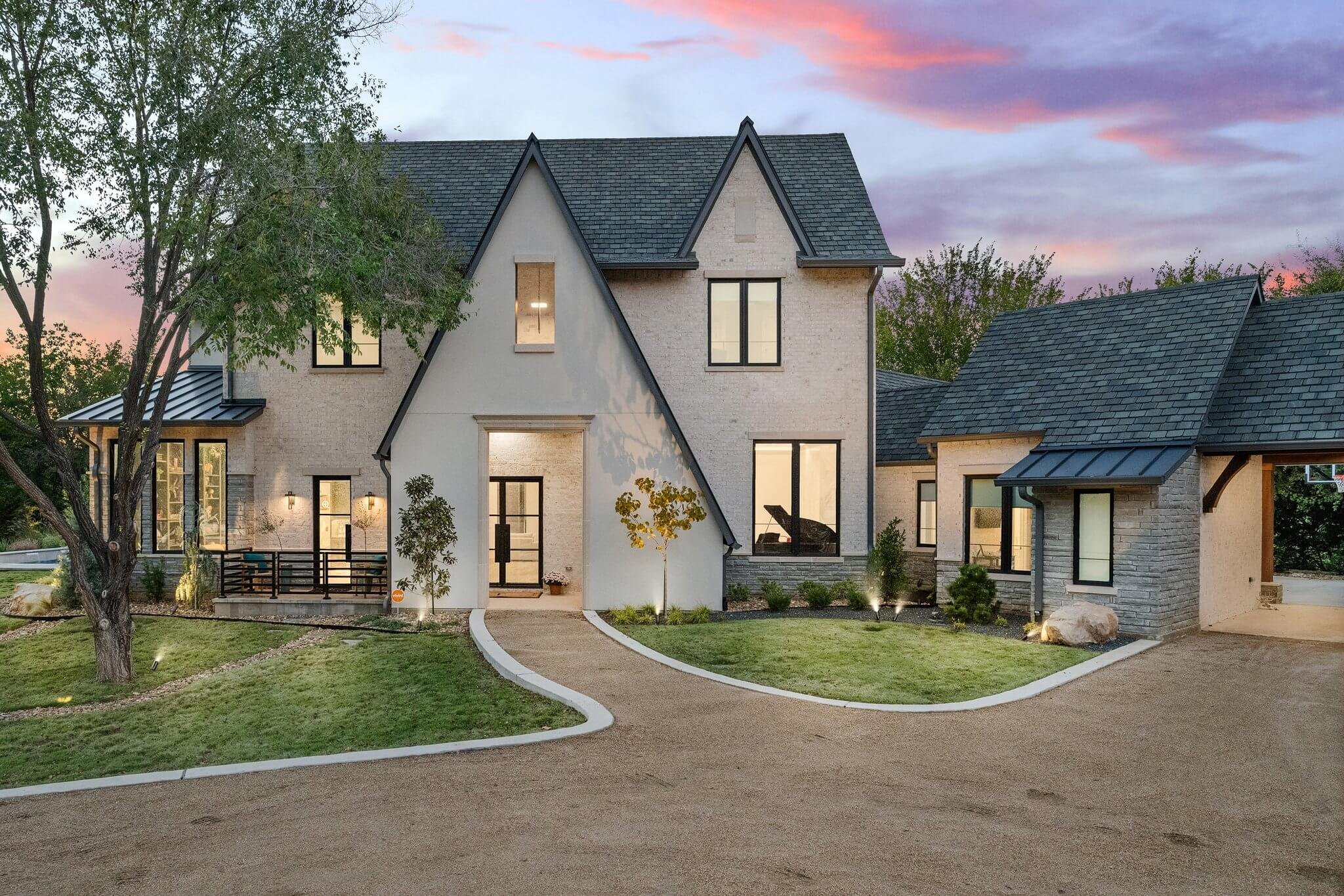 Exterior view of a custom-built luxury home in Colleyville, Texas, featuring beautiful landscaping and serene surroundings.