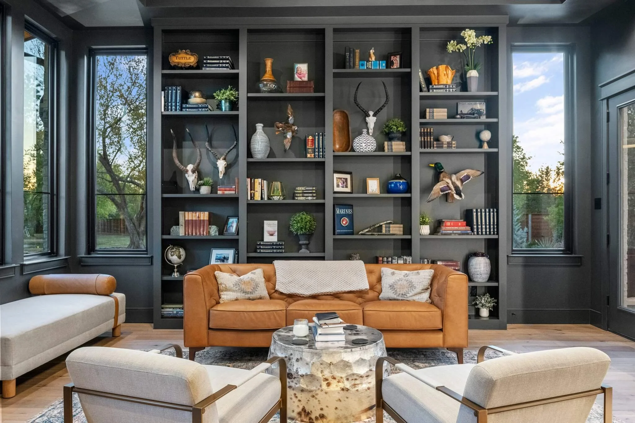 Library area in a luxury home showcasing a custom bookshelf with decorative items and books.