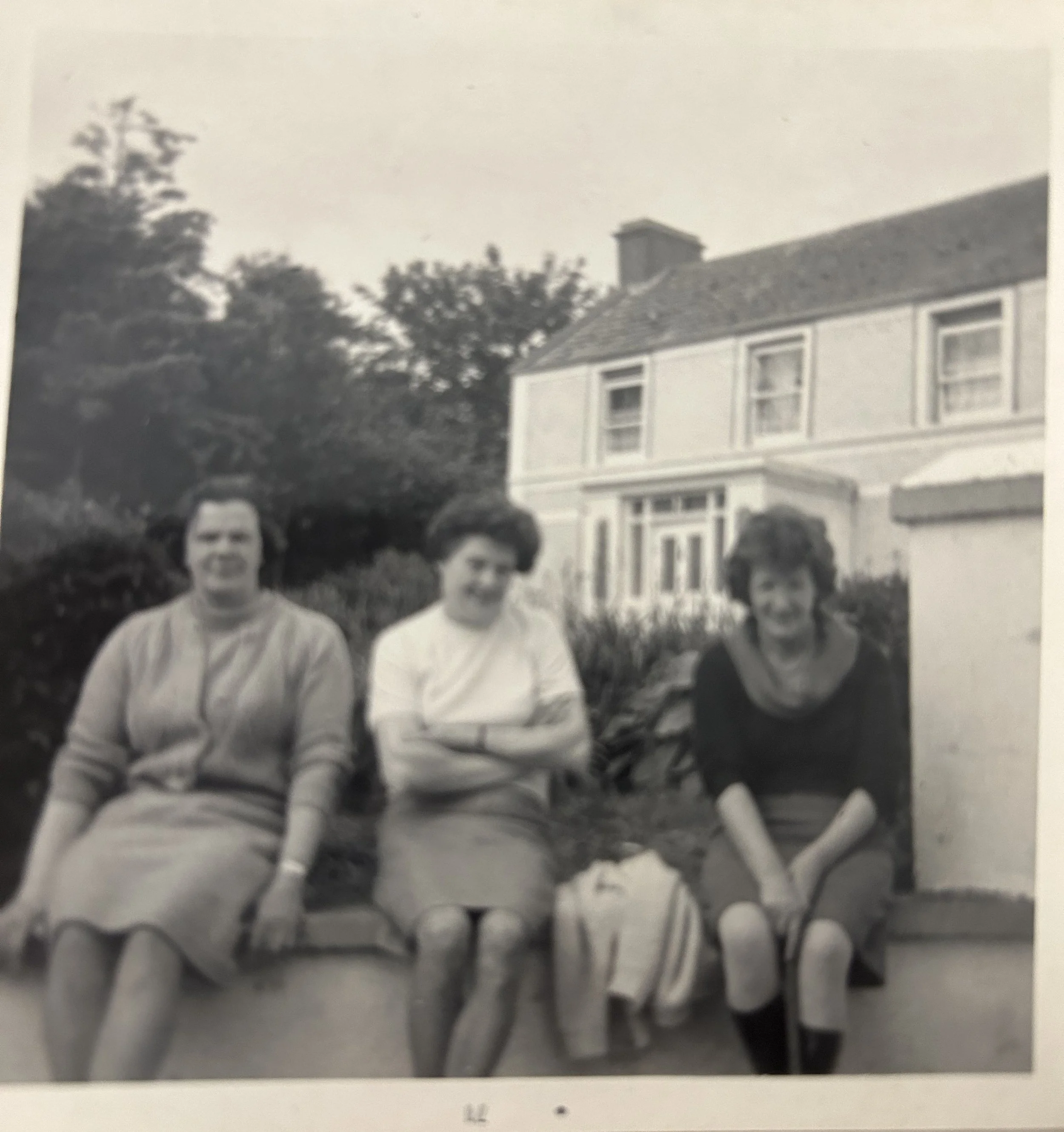 1960s photo of family in front of the house