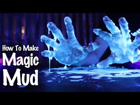 Two hands covered in glowing blue magic mud, with text saying 'How To Make Magic Mud'.
