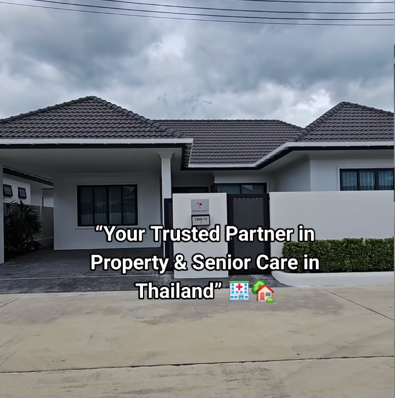 Modern house with dark tiled roof, white walls, and a small front yard. Overcast sky. in Huahin, Thailand
