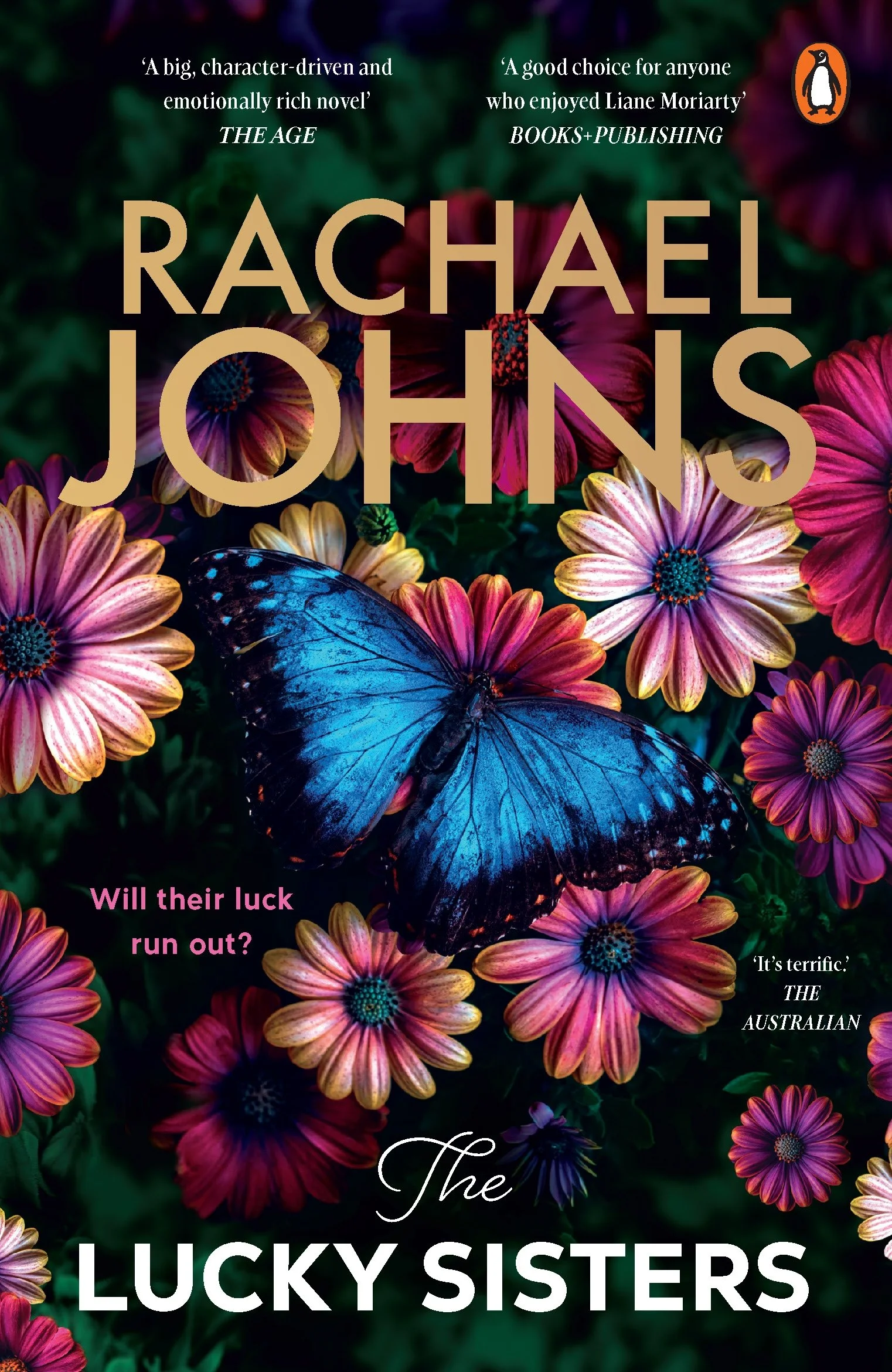 A book cover featuring colorful flowers and a large blue butterfly with the title 'The Lucky Sisters' by Rachael Johns. Quotes from The Age and The Australian are at the top and bottom, and pink text asks if their luck will run out.