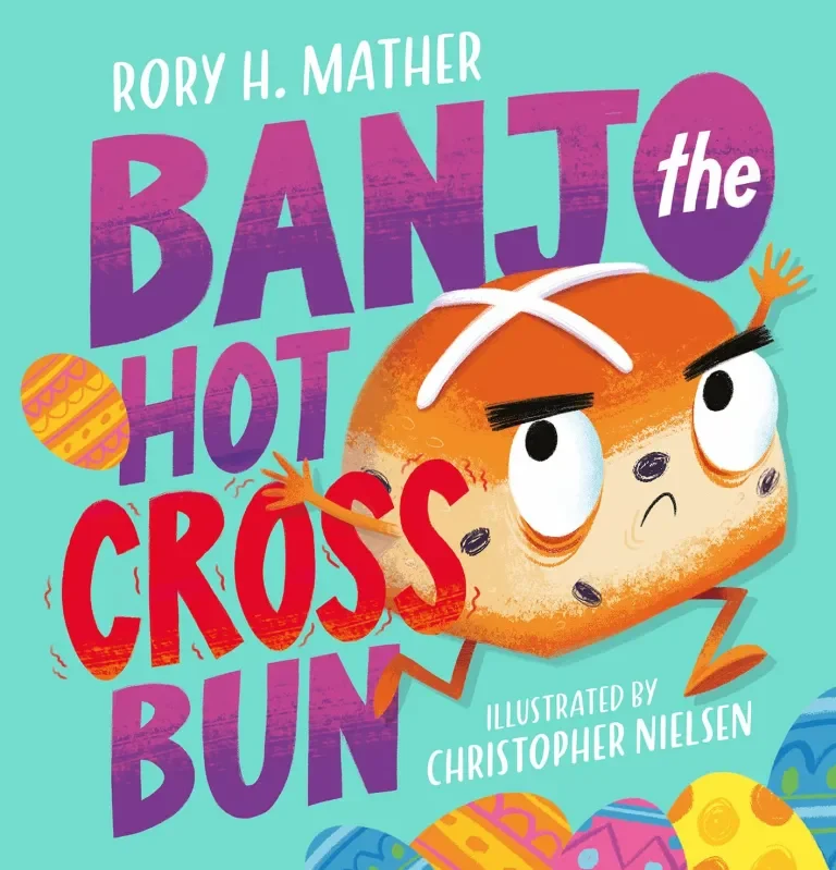 Book cover for 'Banjo the Hot Cross Bun' by Rory H. Mather, illustrated by Christopher Nielsen, features a cartoon hot cross bun with expressive eyes, eyebrows, and limbs, surrounded by colorful, decorated Easter eggs.