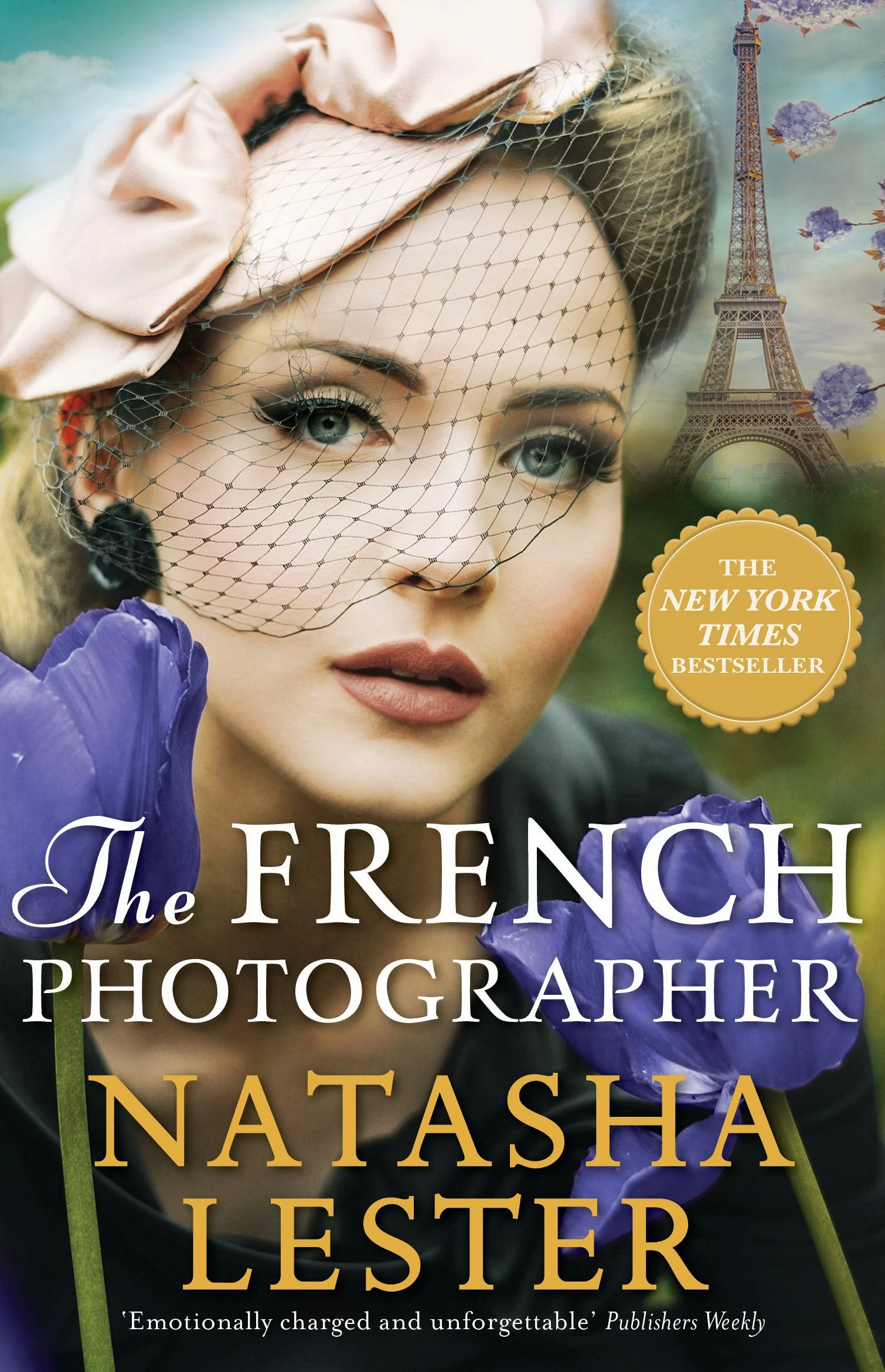 Close-up of a woman with vintage makeup and a netted fascinator, holding purple iris flowers, with a background of the Eiffel Tower and cherry blossoms, and a gold badge that says 'The New York Times Bestseller'.