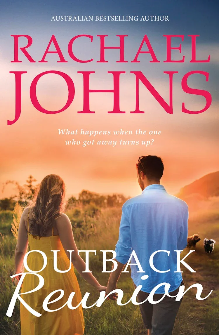 Book cover of 'Outback Rebound' by Rachael Johns featuring a man and woman holding hands in a grassy field at sunset, with trees and hills in the background.