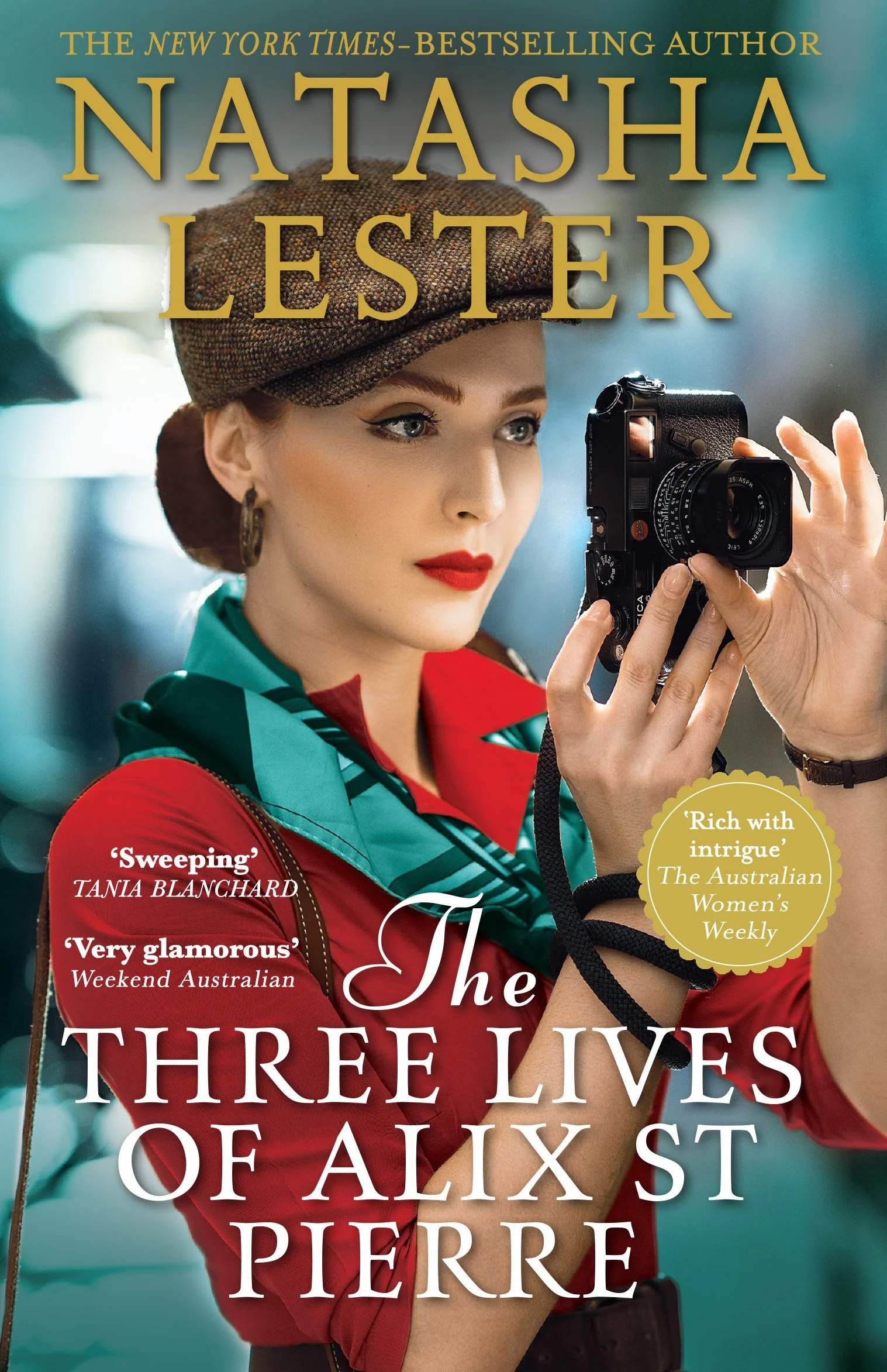 Book cover featuring a woman with makeup and a vintage camera, wearing a red and teal outfit, with various quotes and text about the book and author Natasha Lester.