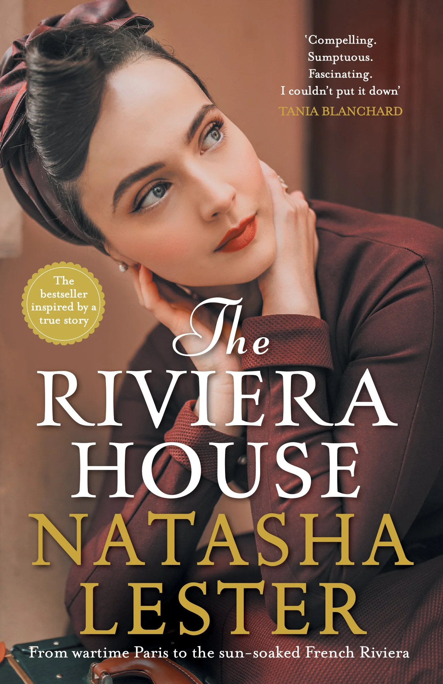Close-up of a woman with vintage makeup and a headscarf, posing with her hand on her chin. The image is the cover of a book titled 'The Riviera House' by Natasha Lester, featuring a quote about the book on the upper right.