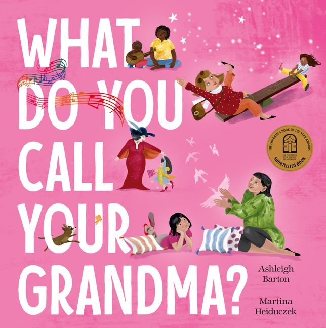 Book cover titled 'What Do You Call Your Grandma?' by Ashleigh Barton and Martina Heiduczek. The cover features colorful illustrations of children and a grandma with a pink background, including a girl playing the guitar, a girl on a seesaw, a girl with a bird, and a girl sitting on the floor.