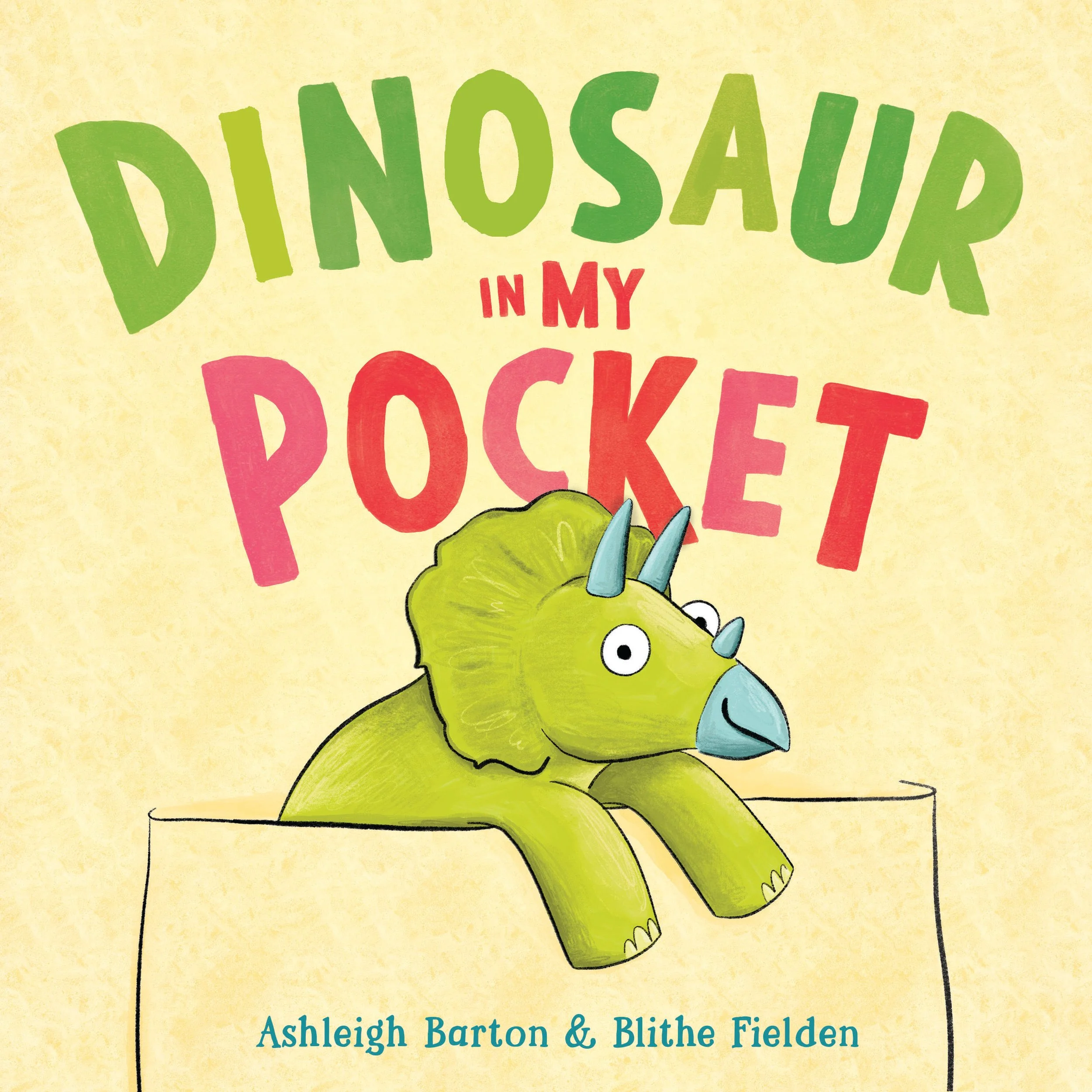 Text on a yellow background reading: "Dinosaurs in My Pocket" with a cartoon illustration of a green dinosaur with blue spikes.