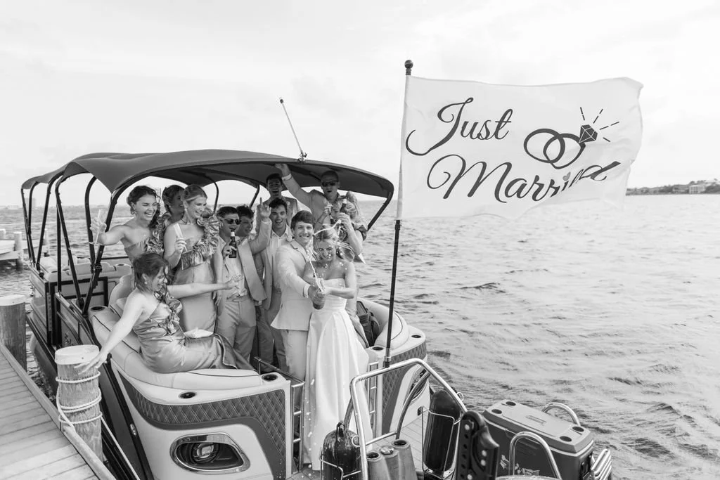 A group of people on a boat celebrating a wedding, with a