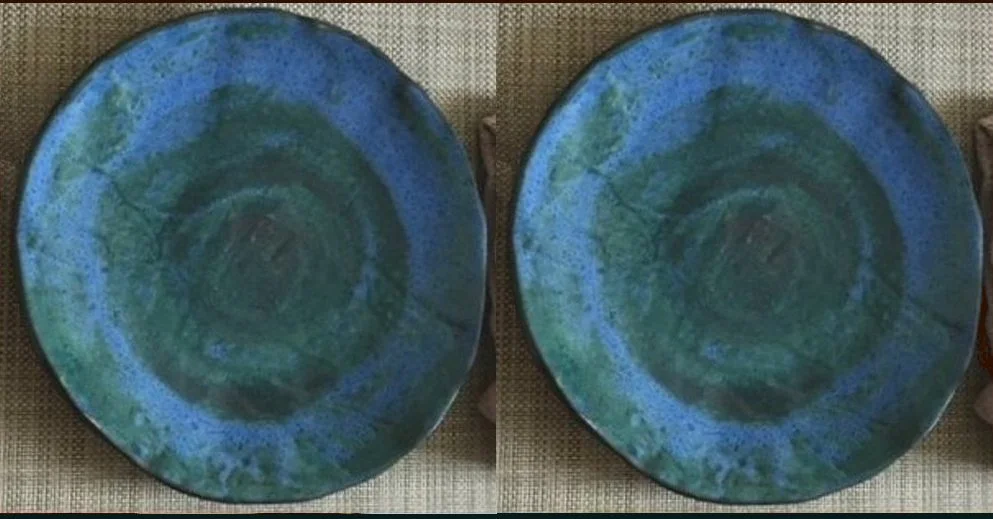 Two round ceramic plates with green and blue abstract patterns, placed on a woven fabric surface.