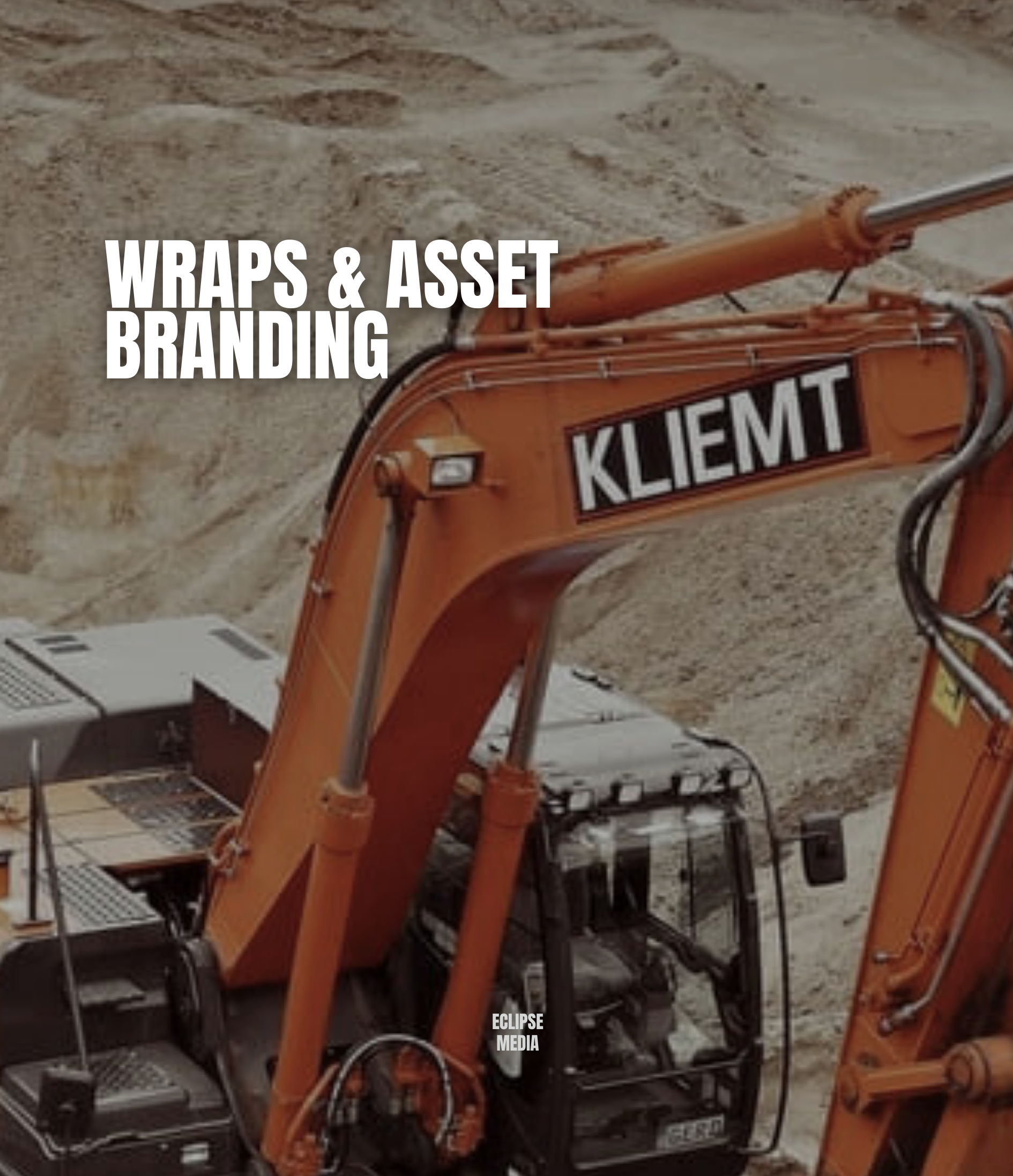 Close-up of an orange construction excavator with black and white branding, on a dusty construction site with bare soil and dirt mounds in the background.