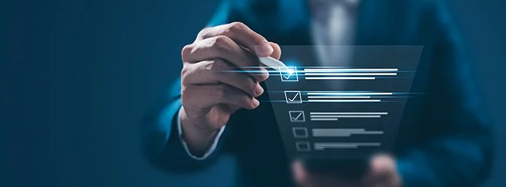 A person in a suit using a digital touchscreen interface with checkboxes and lines, indicating interaction with technology or data management.