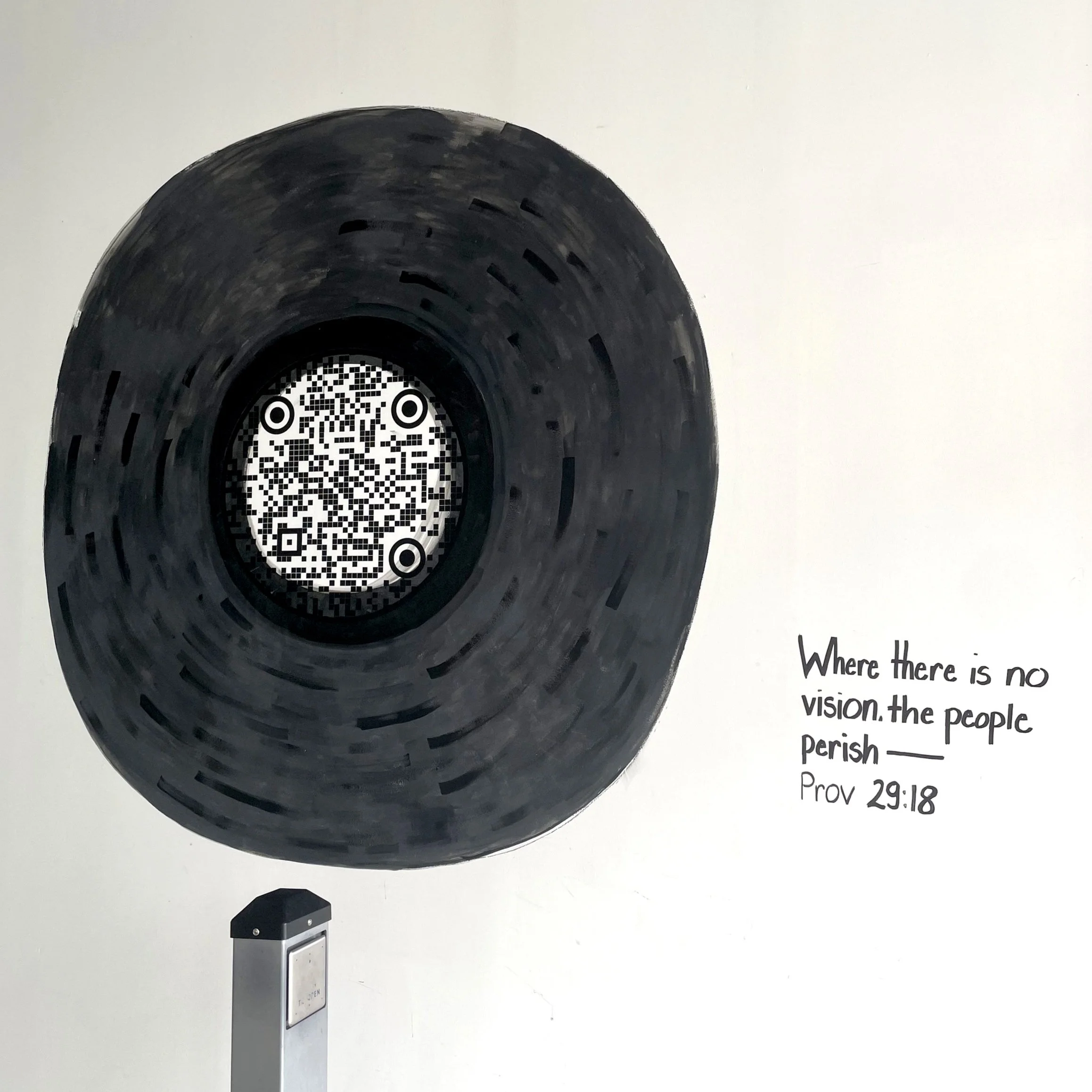 Illustration of a painted black circular object resembling a wheel or tunnel with a QR code at the center, accompanied by a quote from Proverbs 29:18 that says, "Where there is no vision, the people perish."