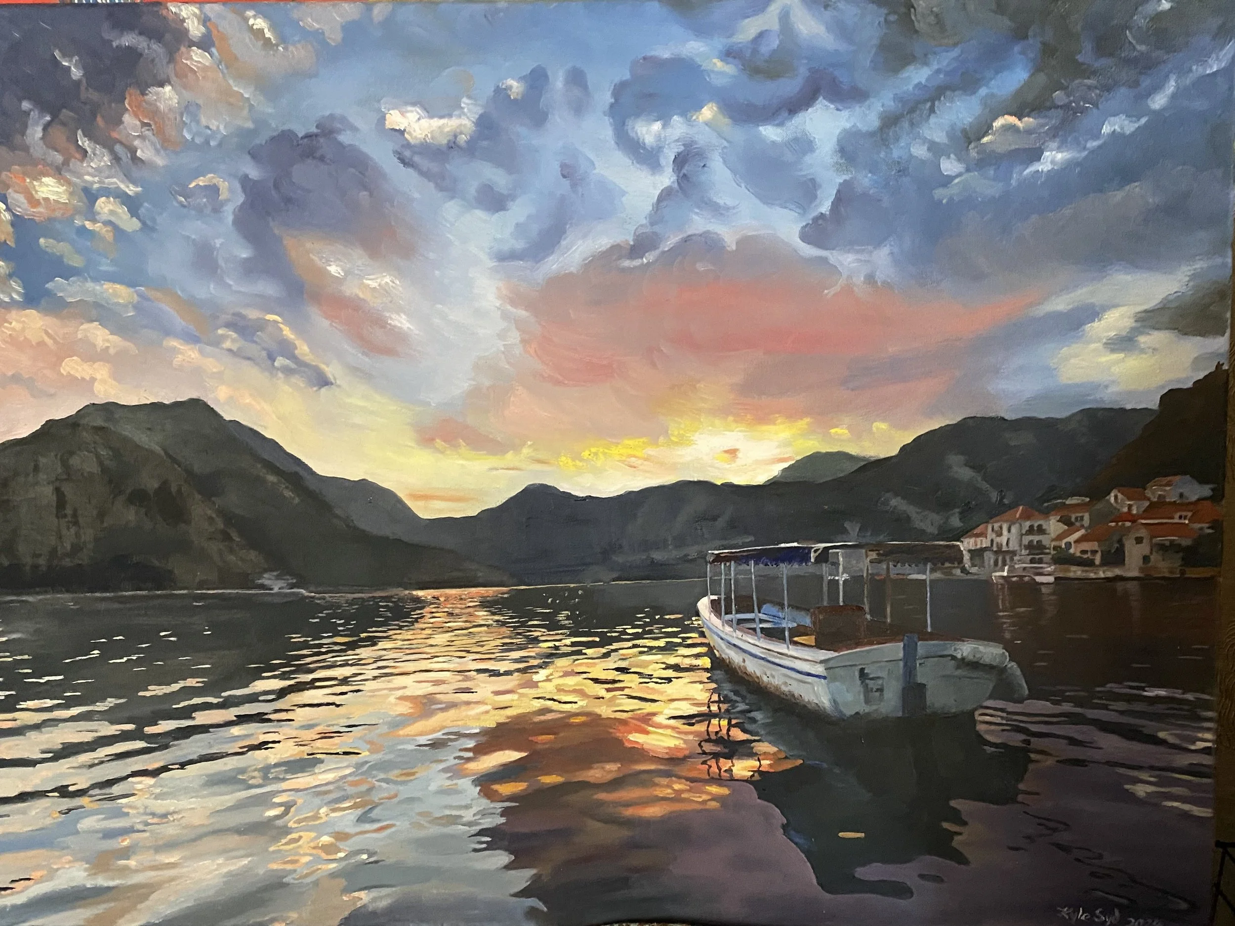 A colorful sunset over a mountain landscape, with a calm body of water in the foreground reflecting the sky's colors and a boat docked near a small town with houses, all painted in a vibrant and impressionistic style.