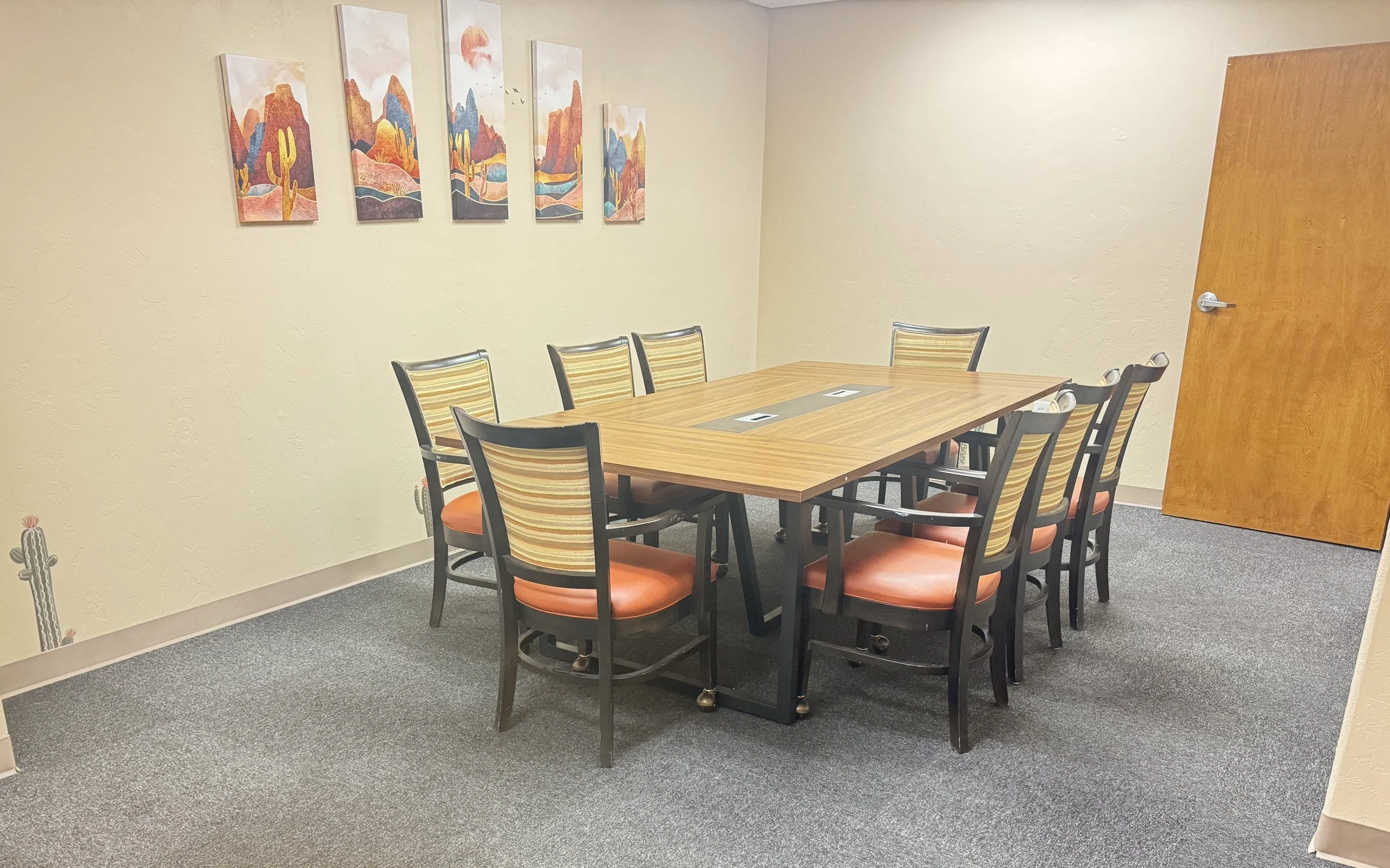 Conference room with a table for 8 and Southwest desert art