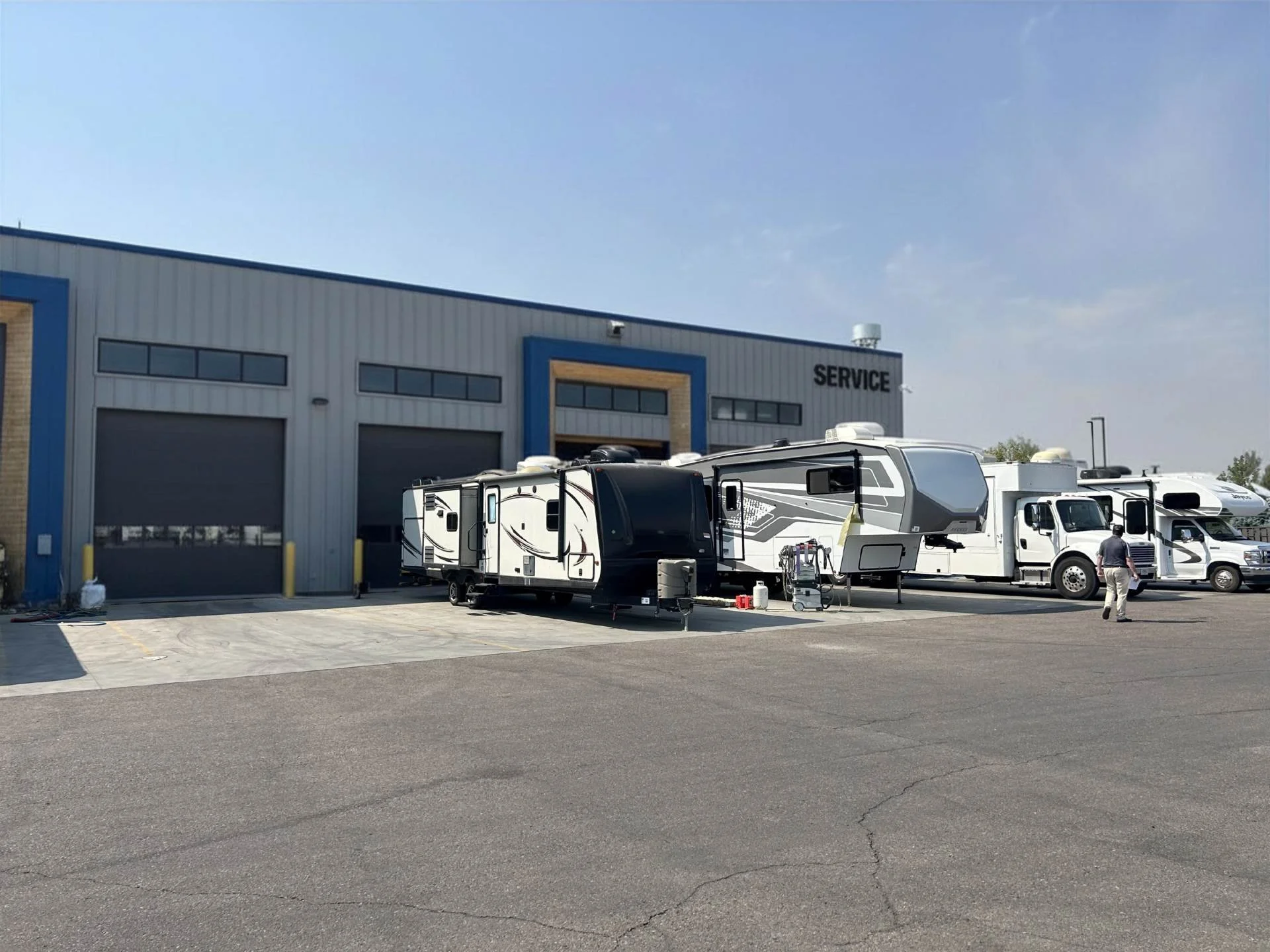 A service building with multiple RVs parked in front