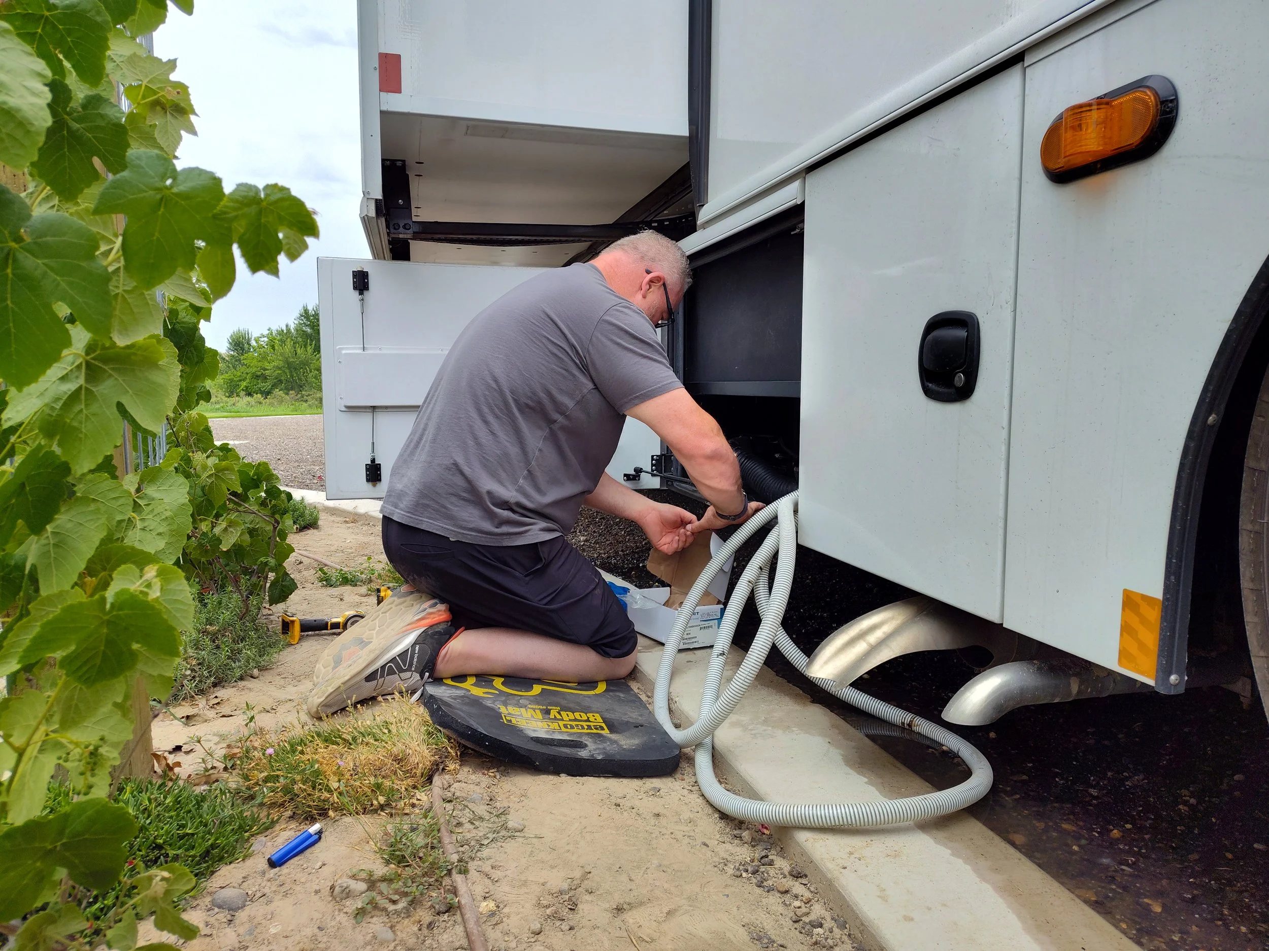 An RVFix Mobile Technician working on an RV in someone's driveway