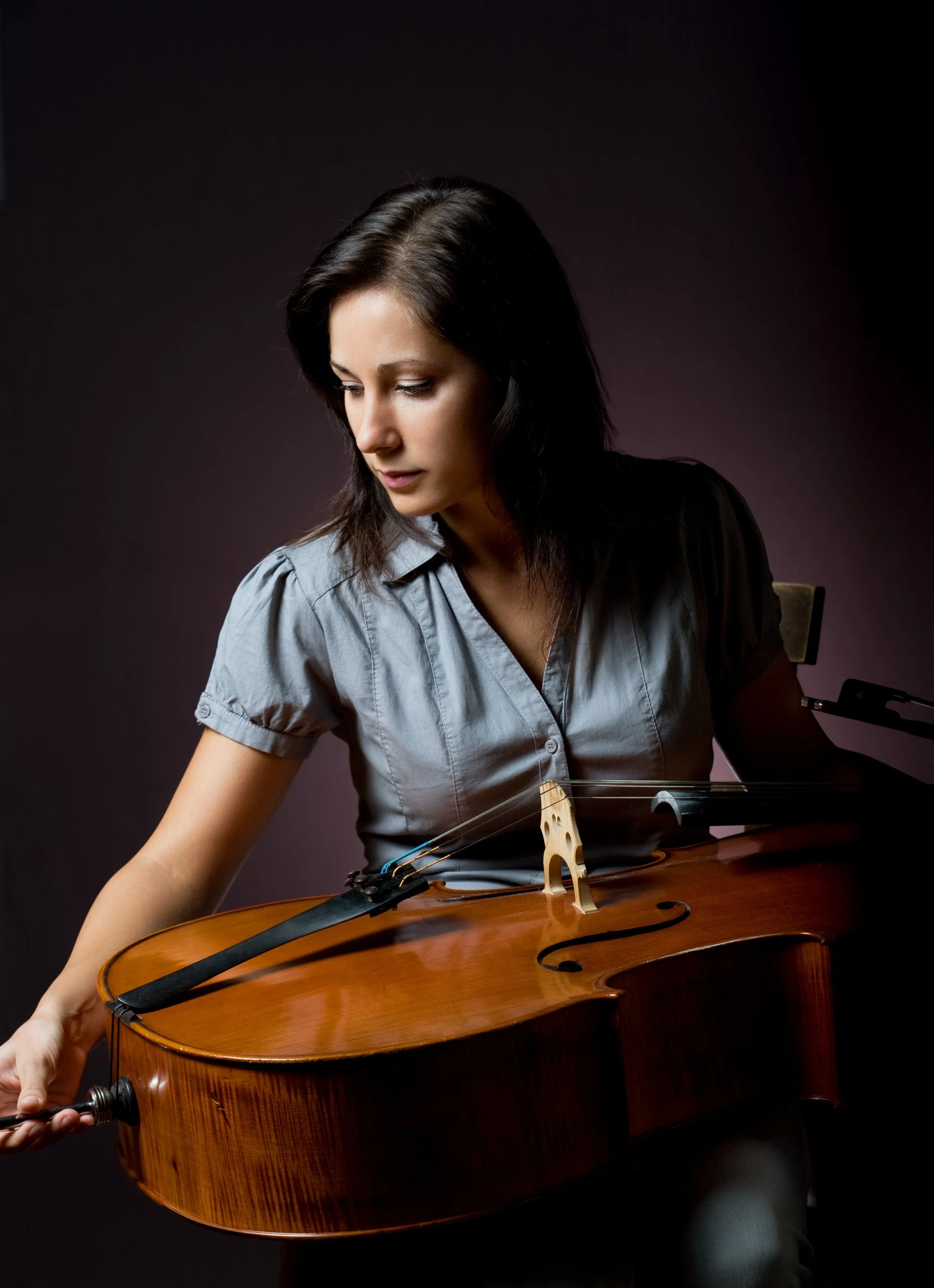 Woman teacher holding a cello.