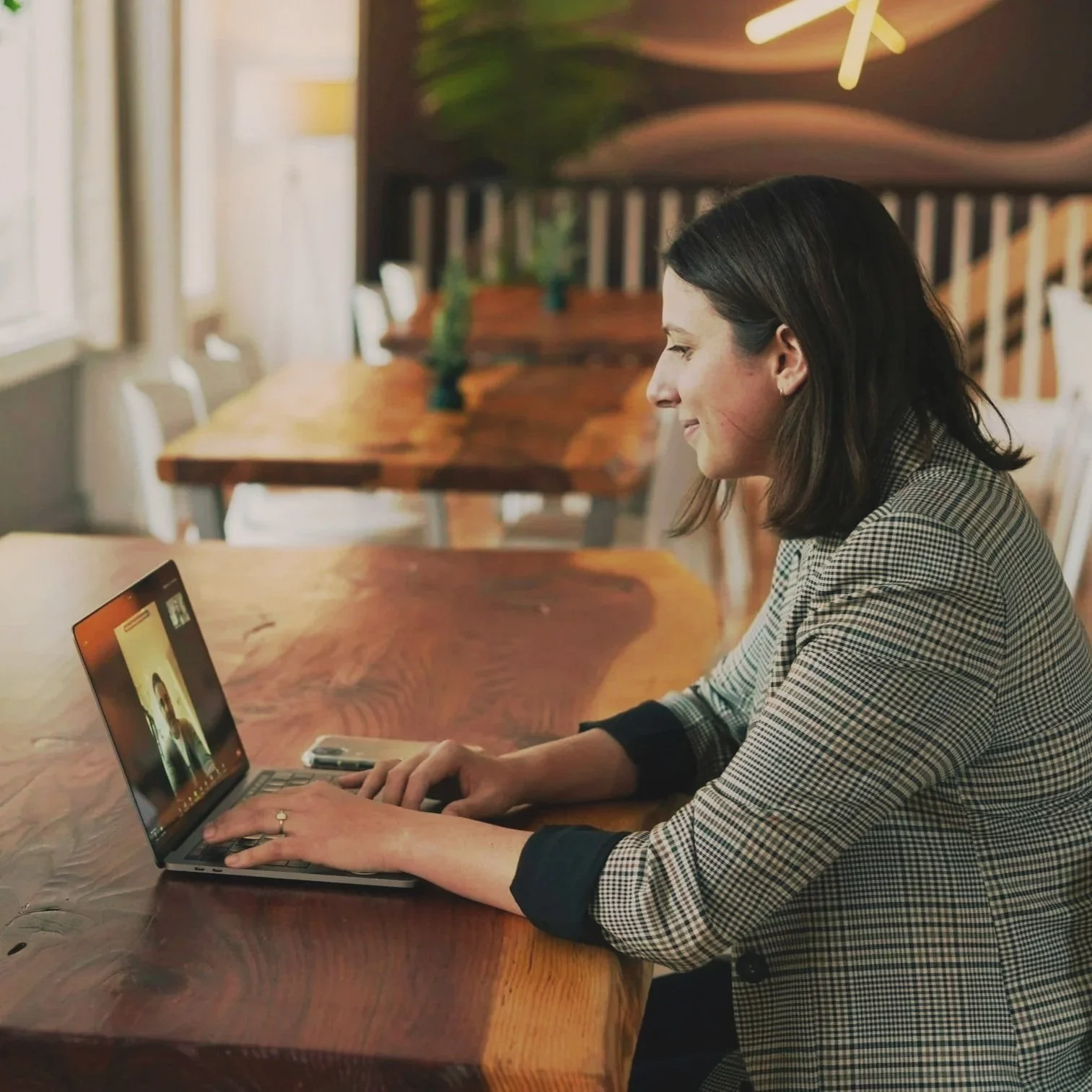 Woman receiving telehealth services on a laptop