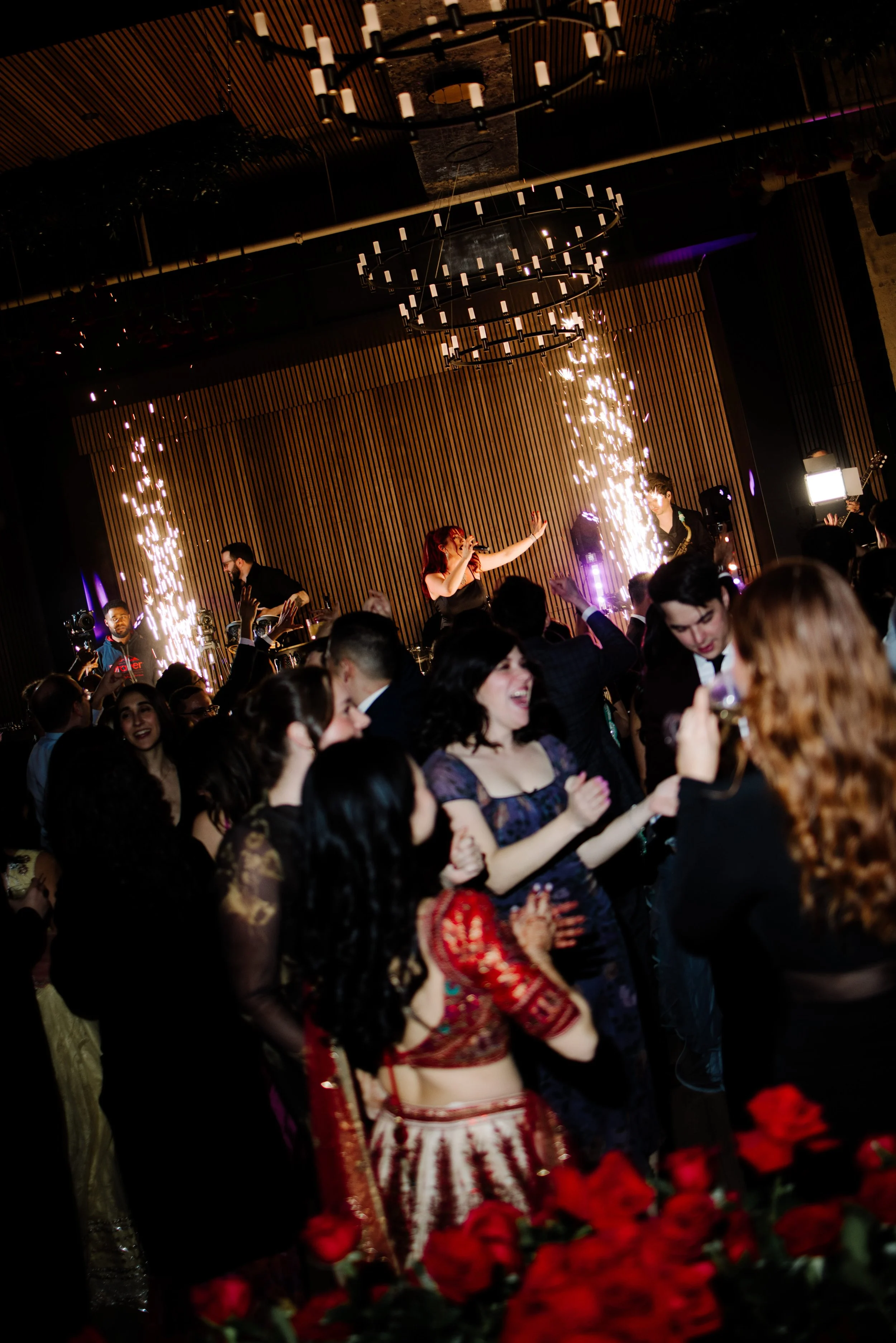Wedding reception dance floor with sparkler effects and live band produced by RDAV