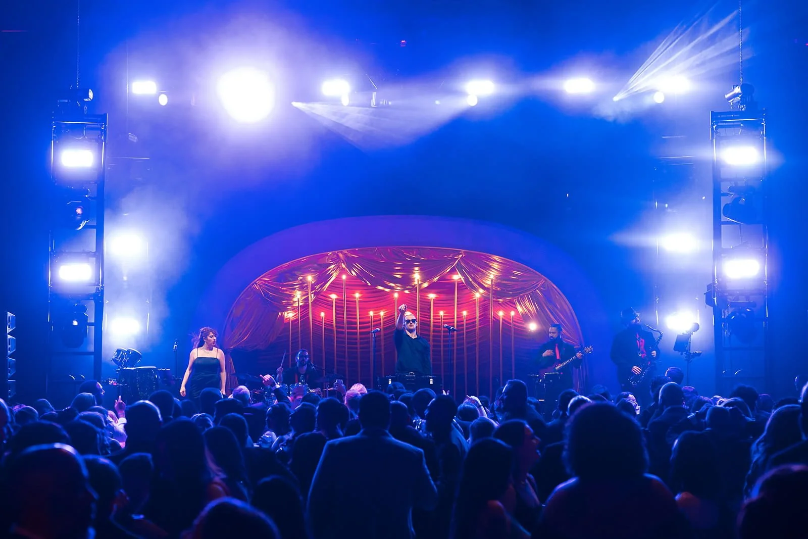 Live event stage with dynamic blue lighting and crowd produced by RDAV