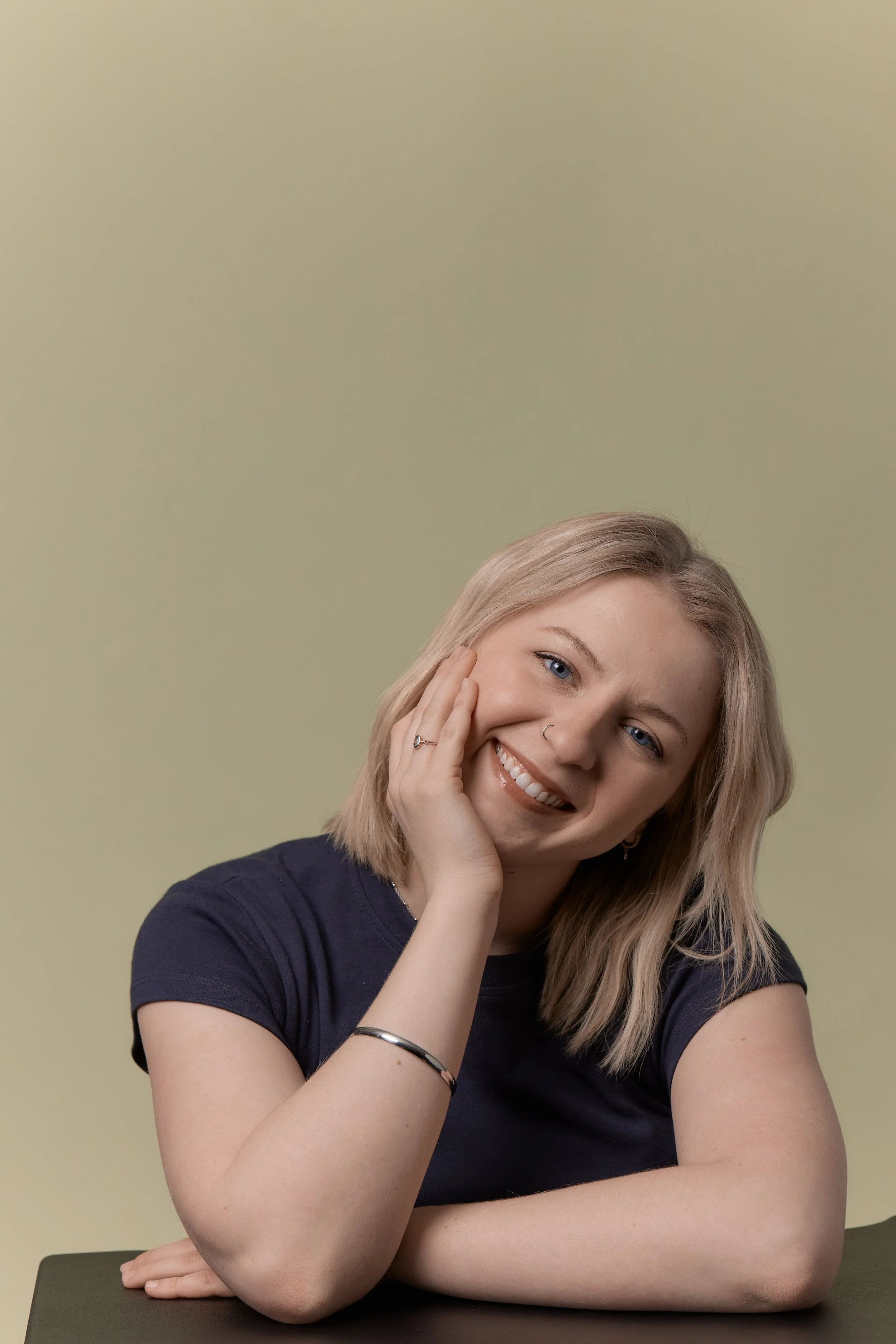 Minnesota bridal makeup artist smiling in professional headshot with soft glam makeup.